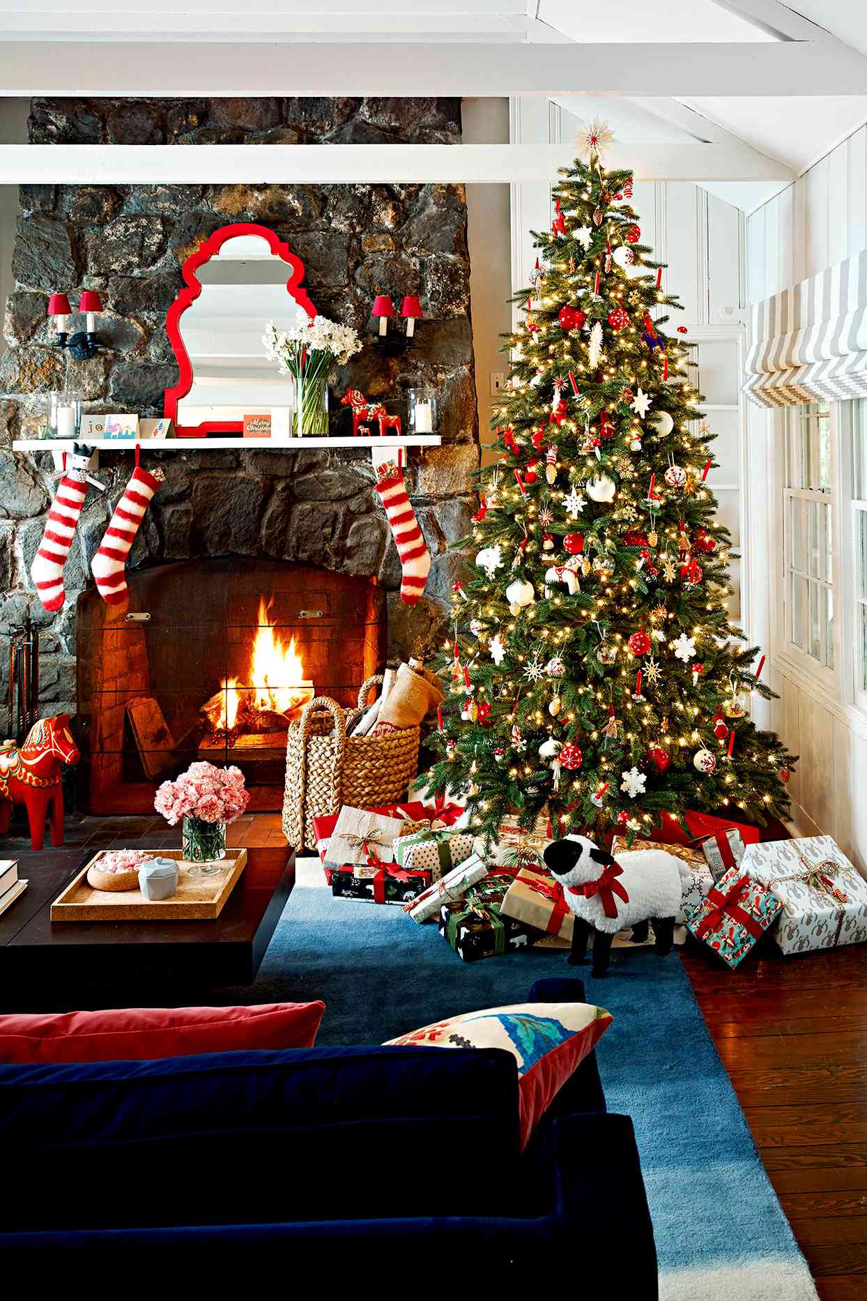 christmas tree and wrapped gifts near fireplace