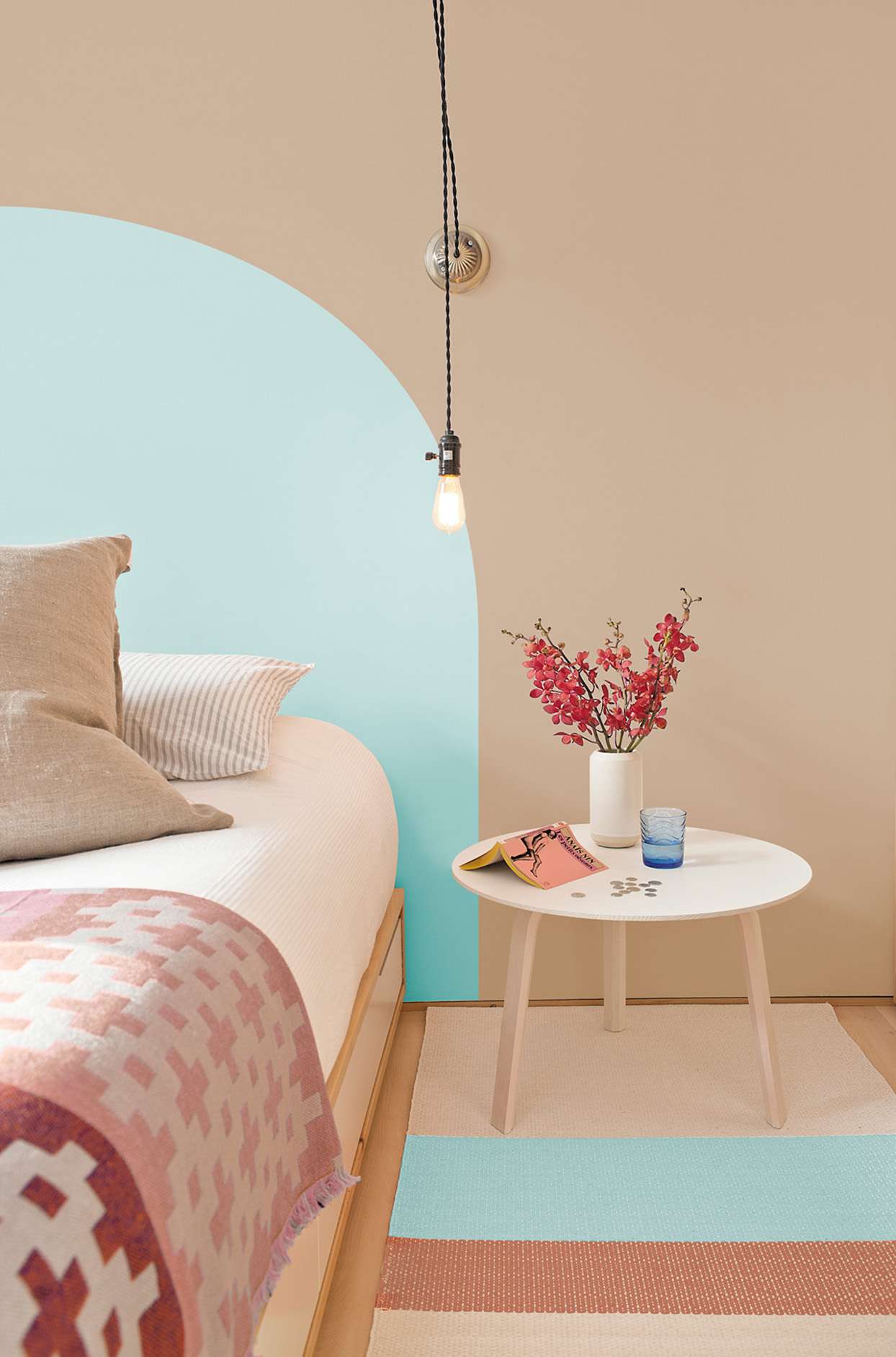 bedroom with beige walls and turquoise painted arch