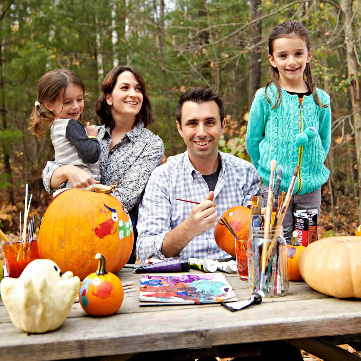 family painting pumpkins