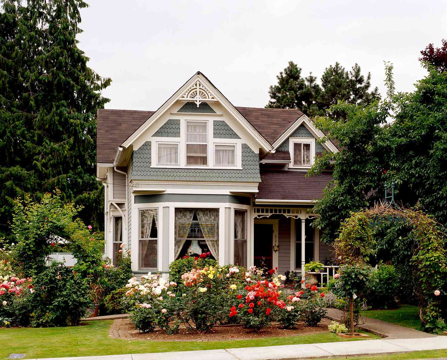two-story Victorian house with roses