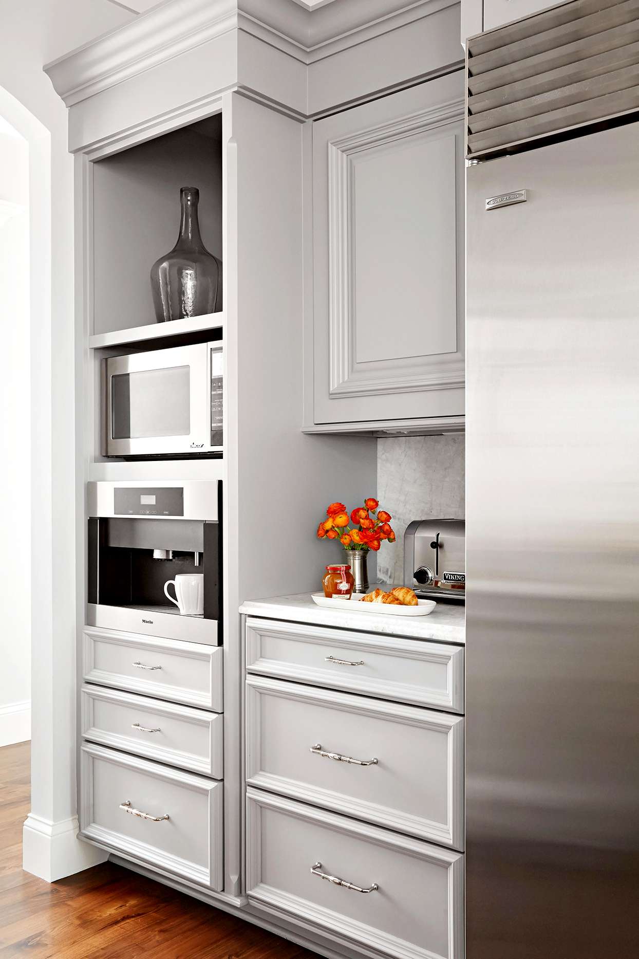 Grey painted cabinetry with stainless steel refrigerator