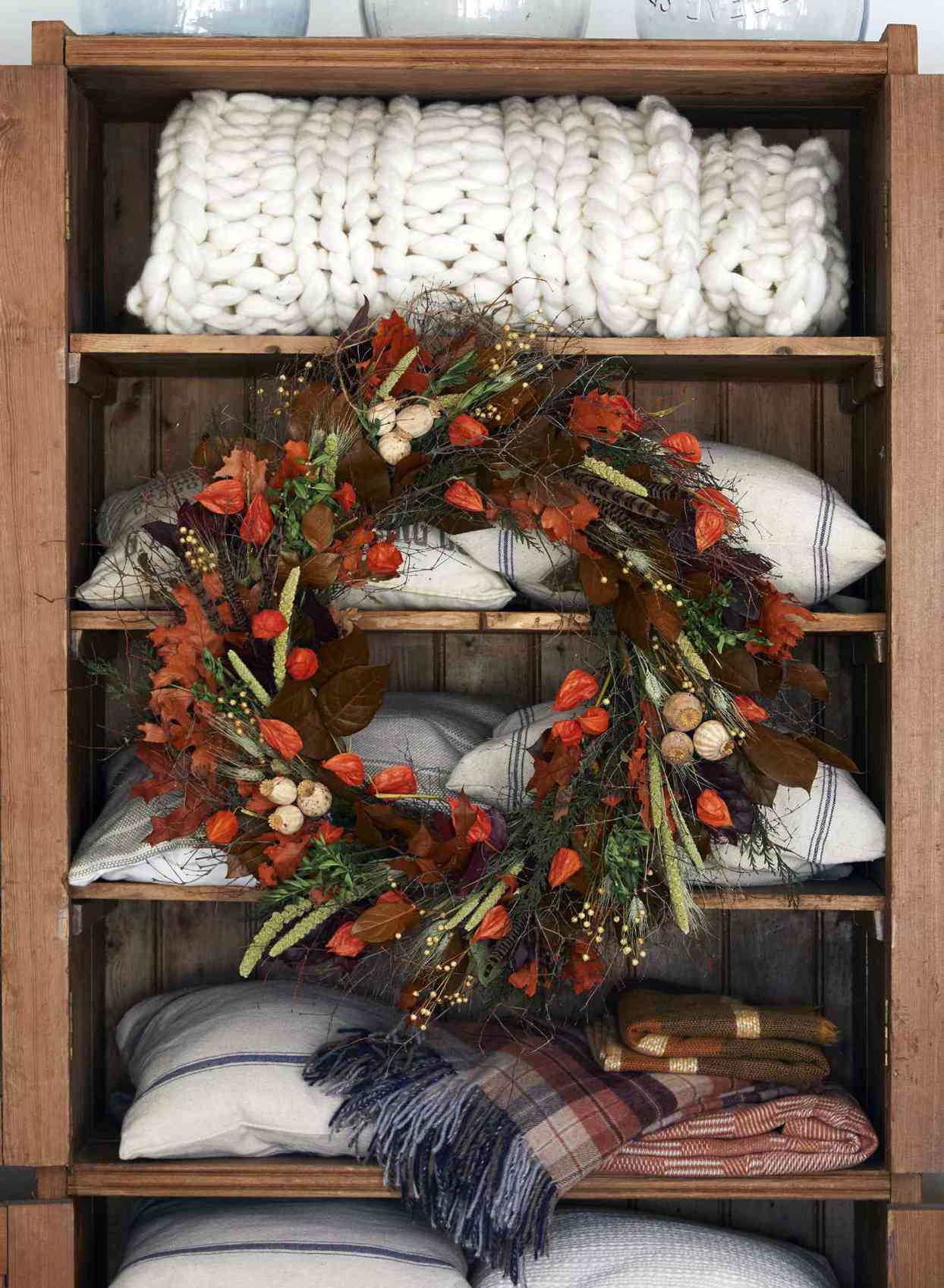 shelves with blankets and wreath