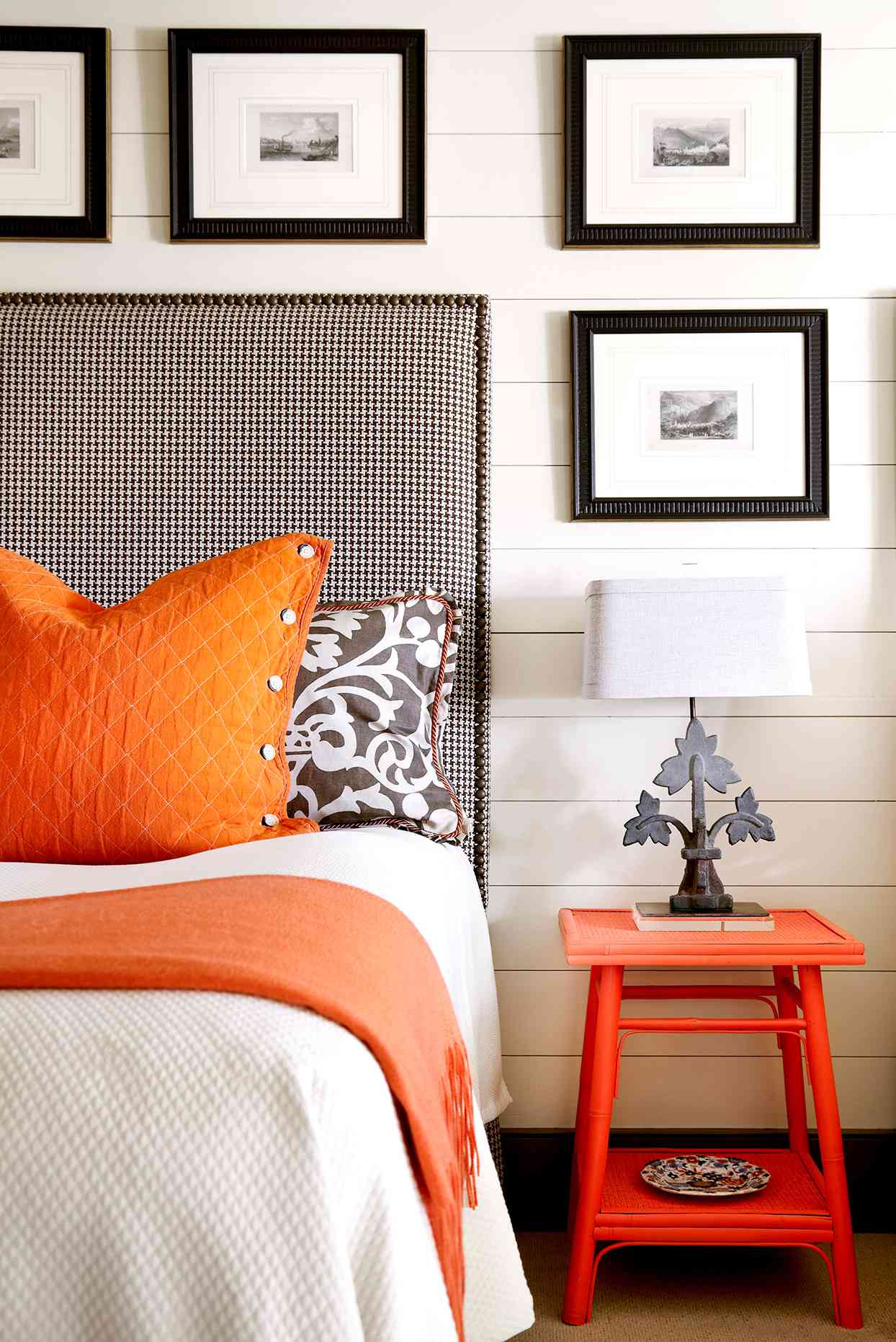 Black and white bedroom with orange accents