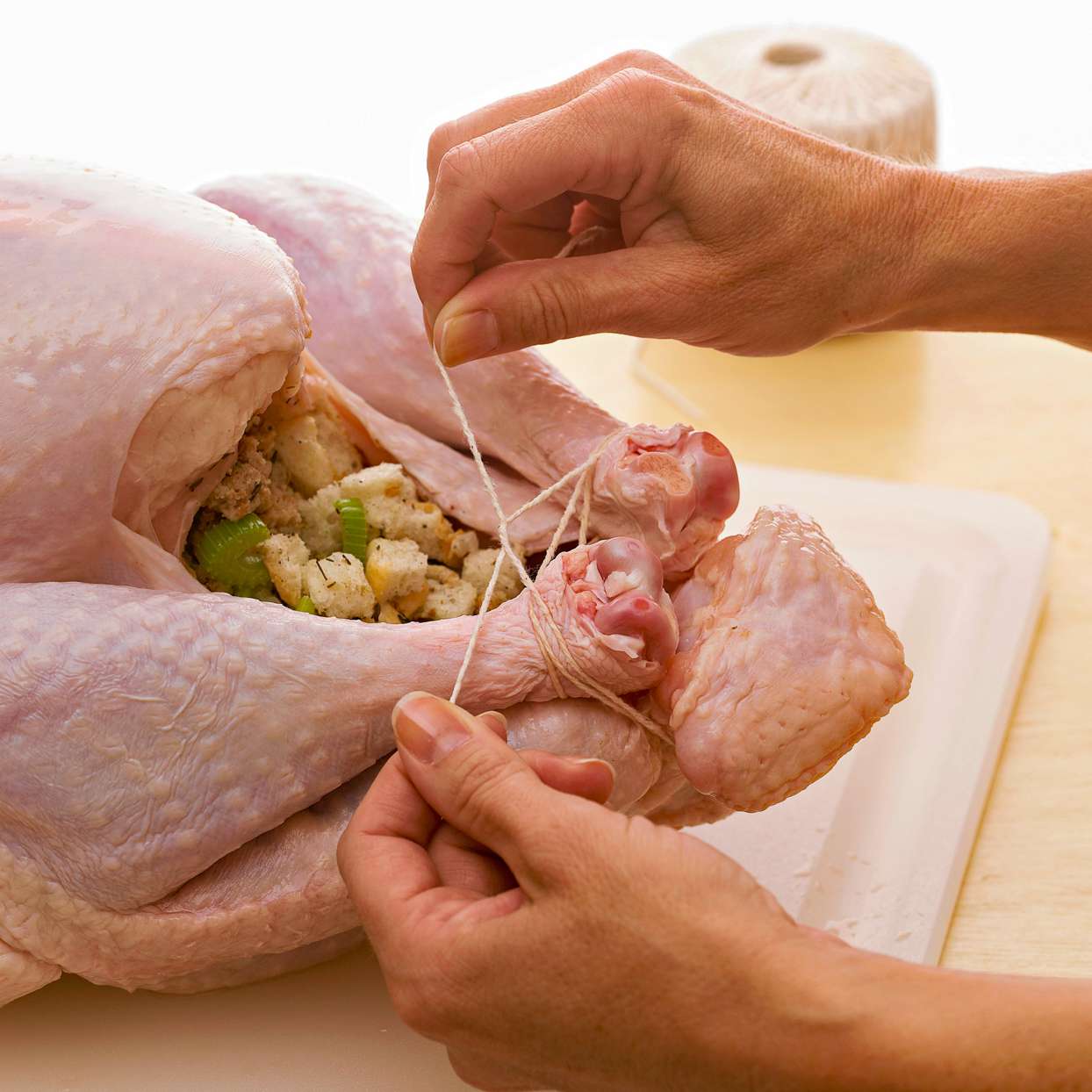 tying turkey legs together to hold in stuffing