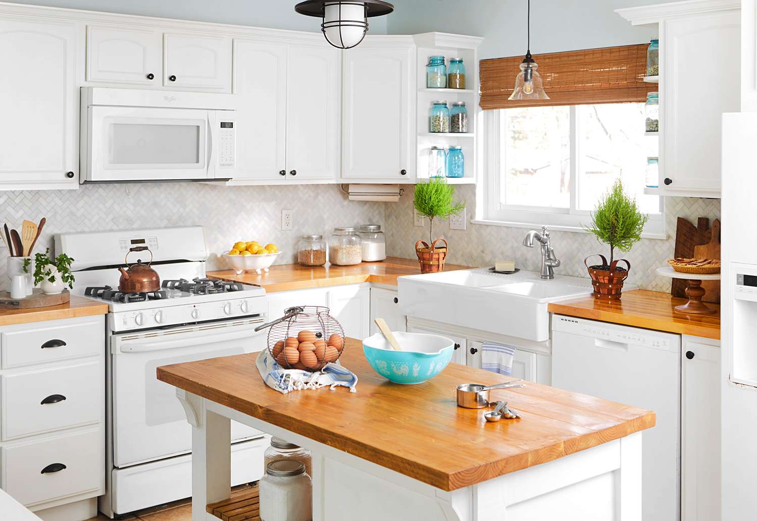 white kitchen with wood counters and island