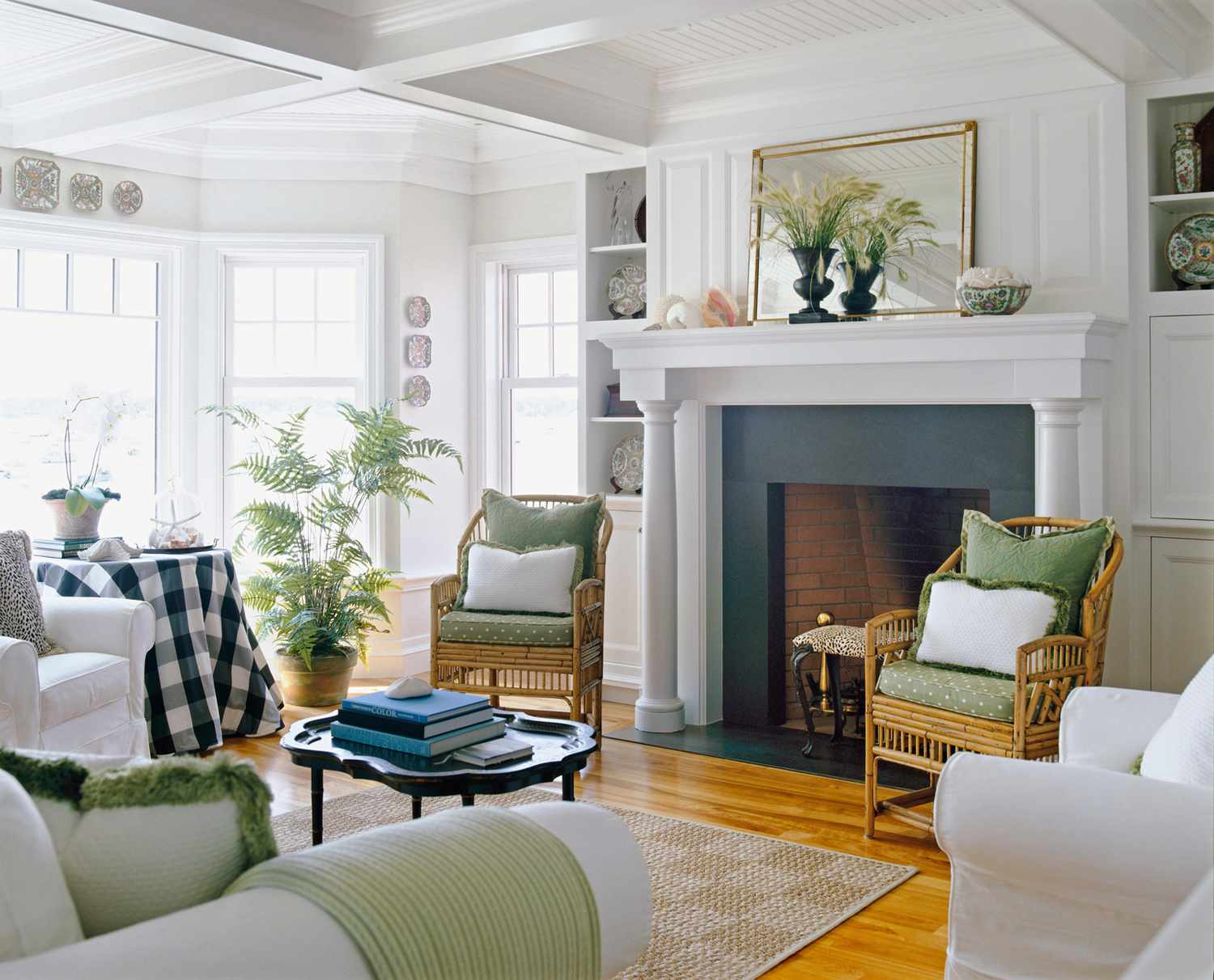 living room green fireplace white columns