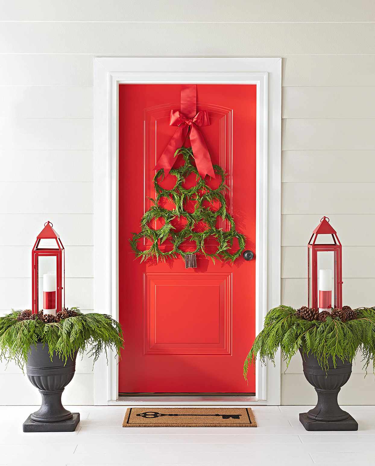 tree-shaped cedar wreath hanging red door
