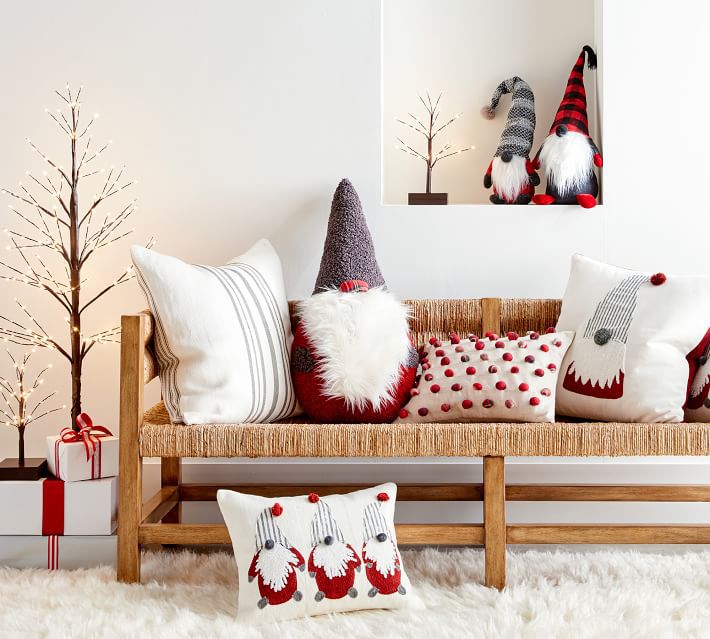 white couch with plush gnomes