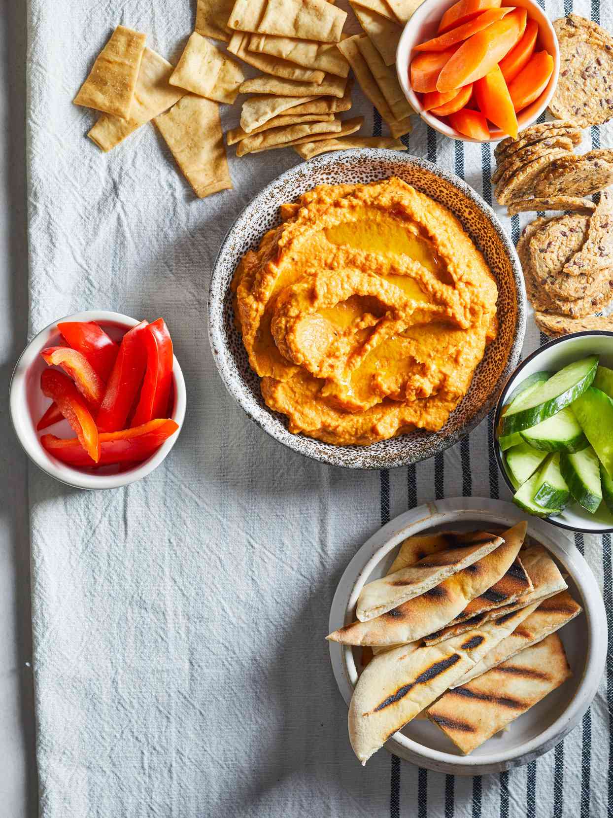 overhead view of Pumpkin-Roasted Red Pepper Hummus with vegetables and pita