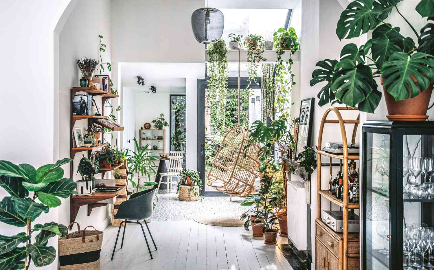 A sunroom filled with lots of houseplants