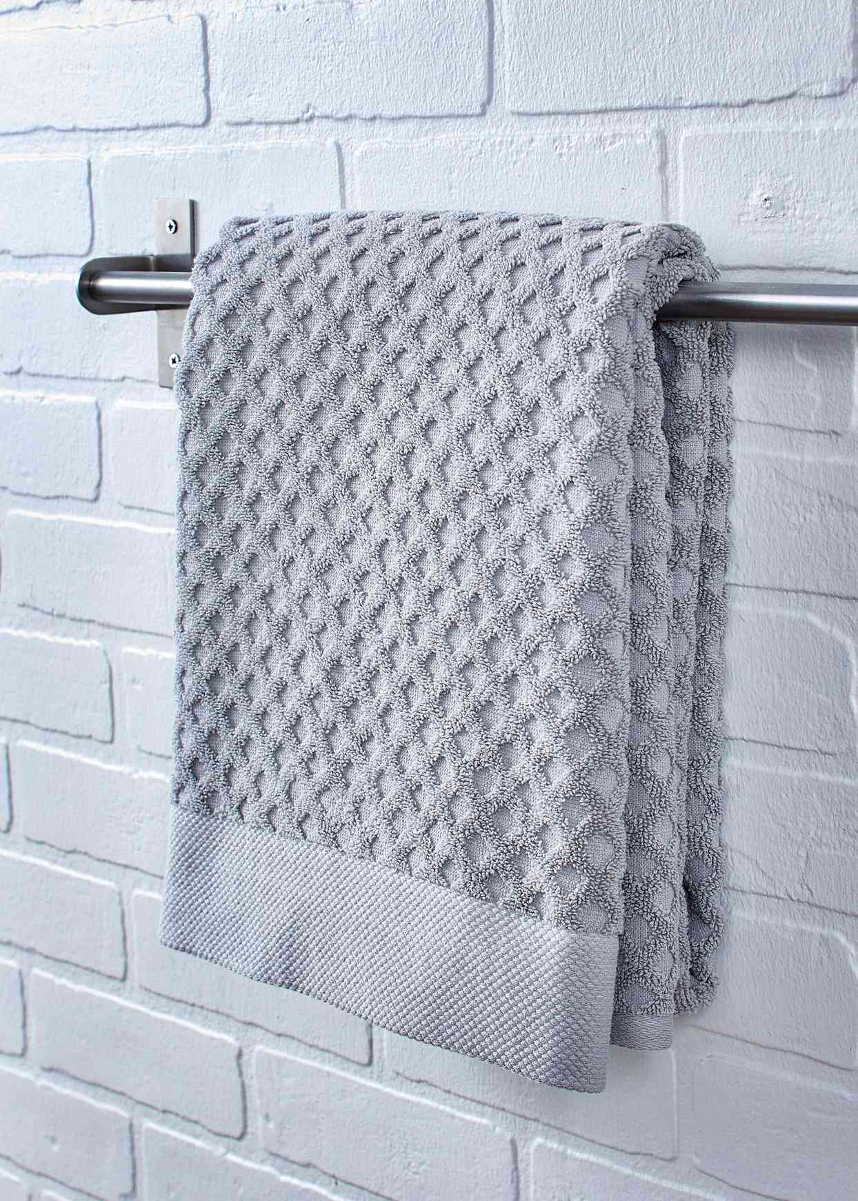 gray towel hanging on bar