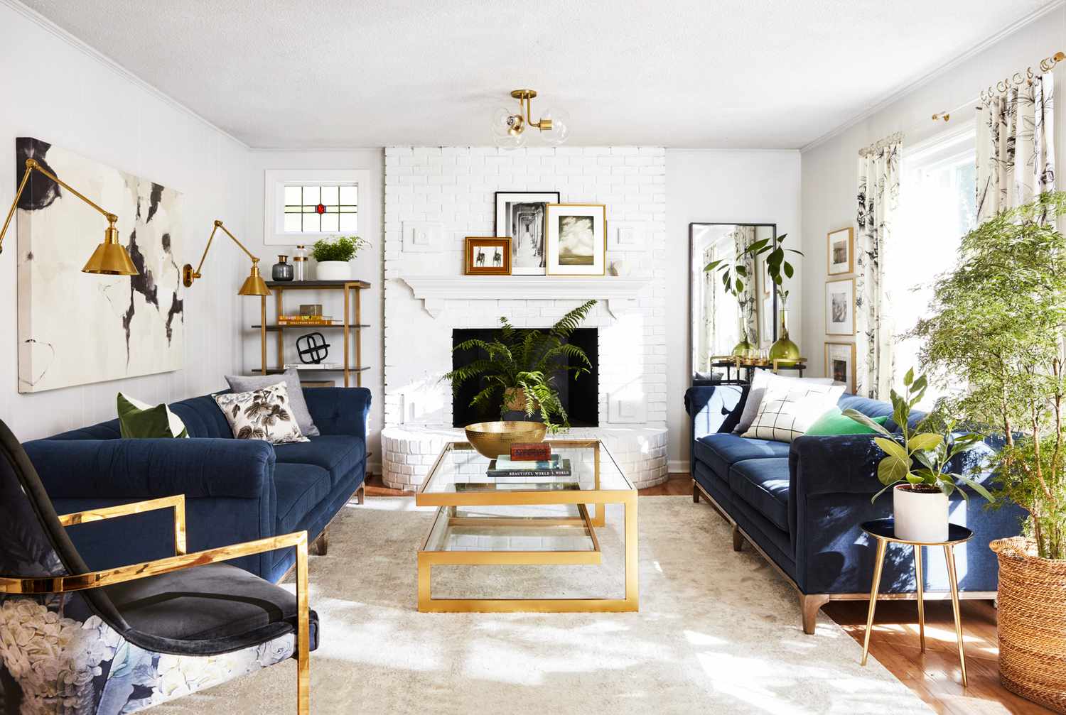 modern blue and white living room with gold accents and plants