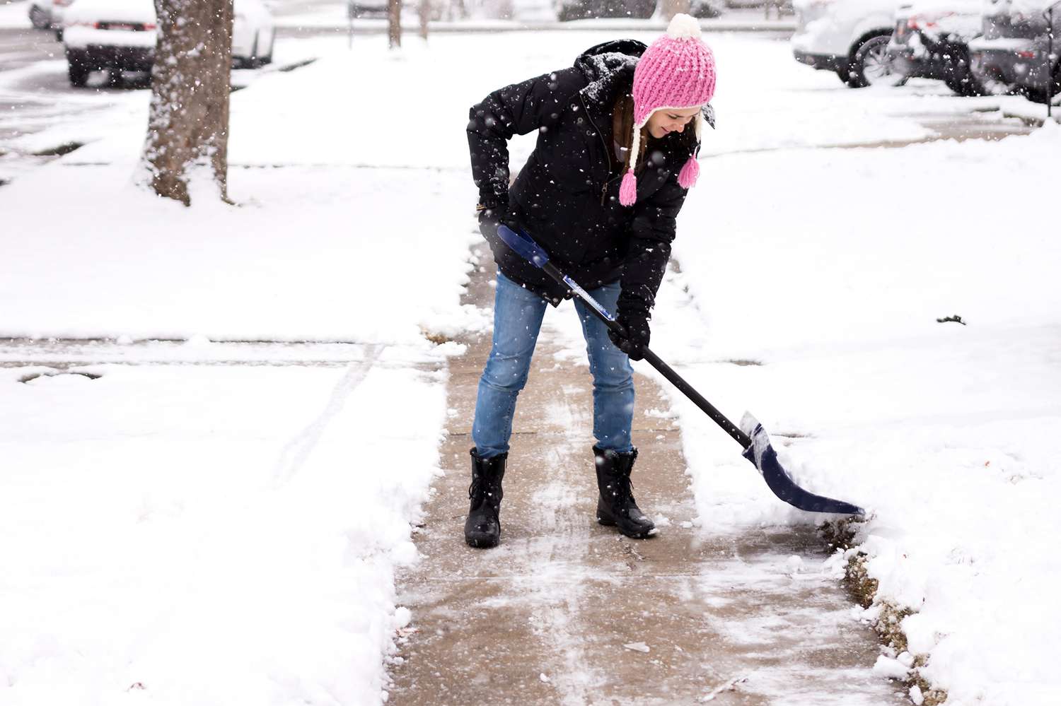 woman shoveling sidewalk