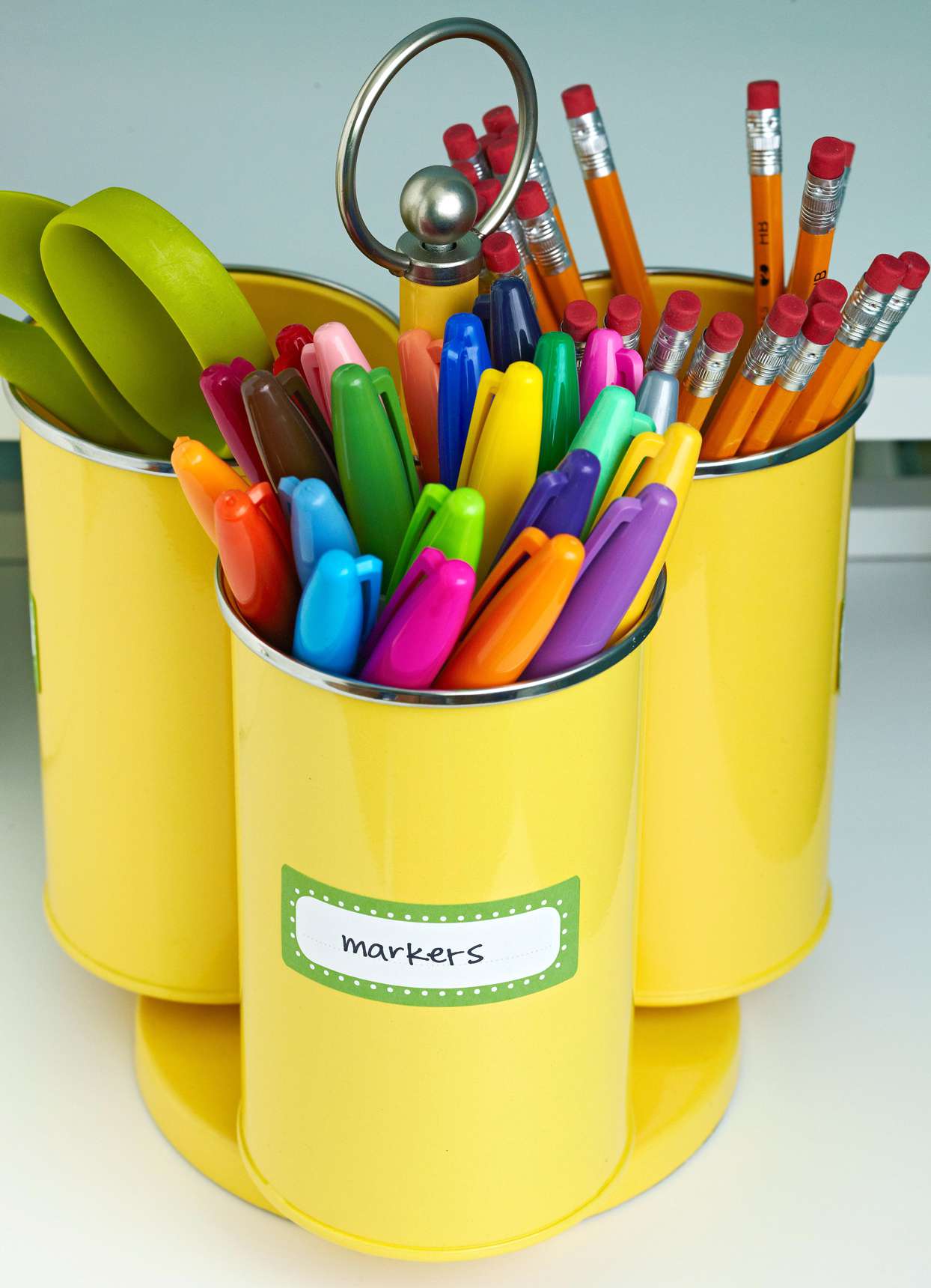 labeled yellow cups with school supplies