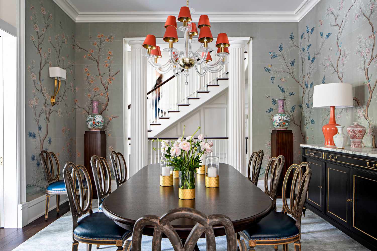 dining room with floral wallpaper and red chandelier