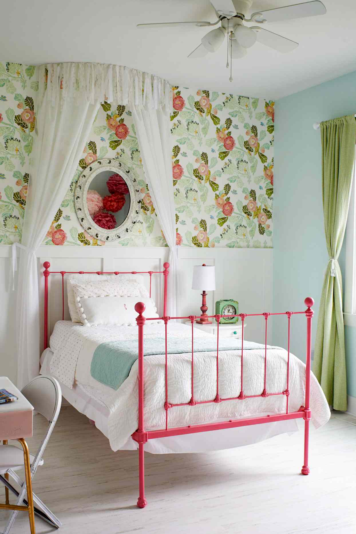 bedroom with green and red flowered wallpaper and canopy bed