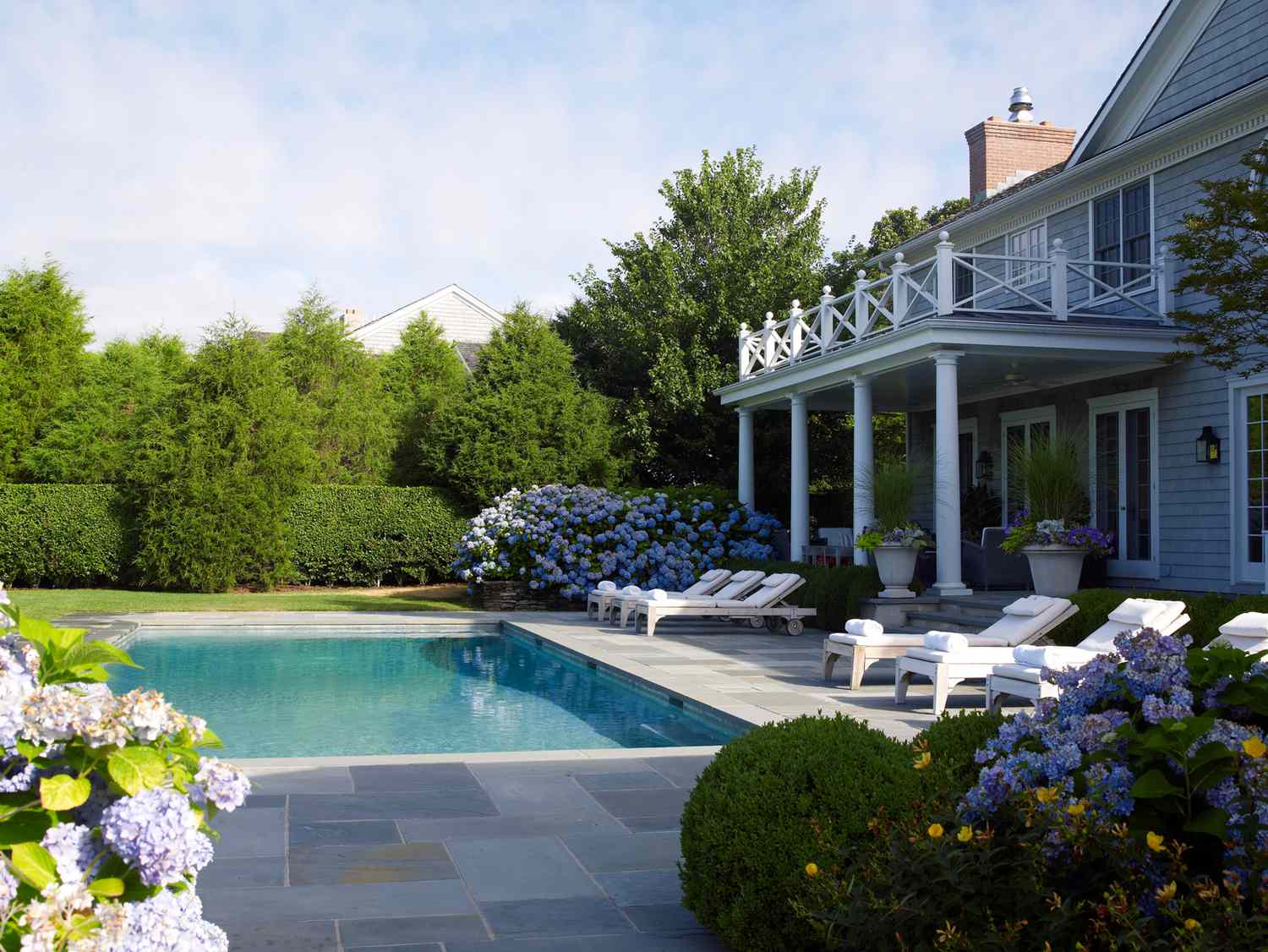 colonial style home in east hampton back exterior with in ground pool