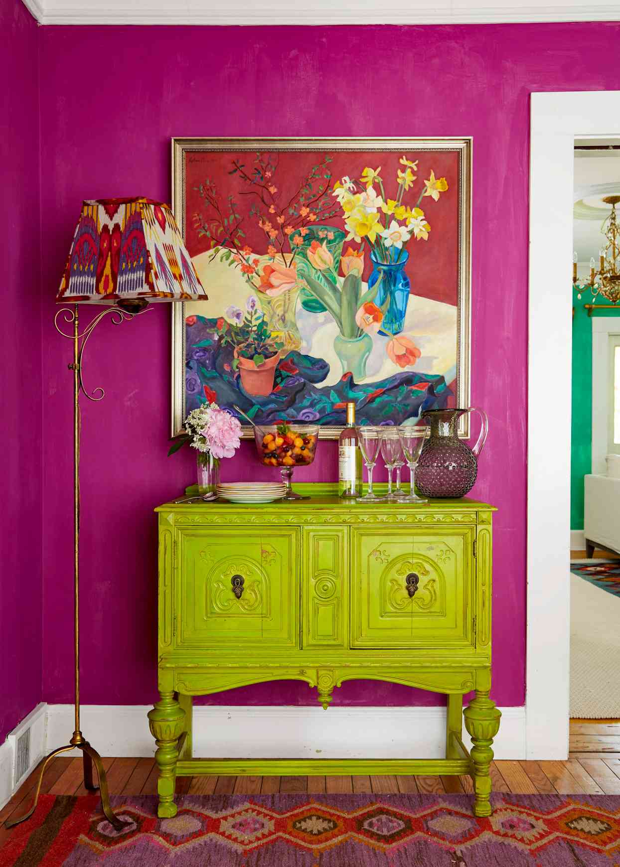 foyer with magenta wall and green dresser