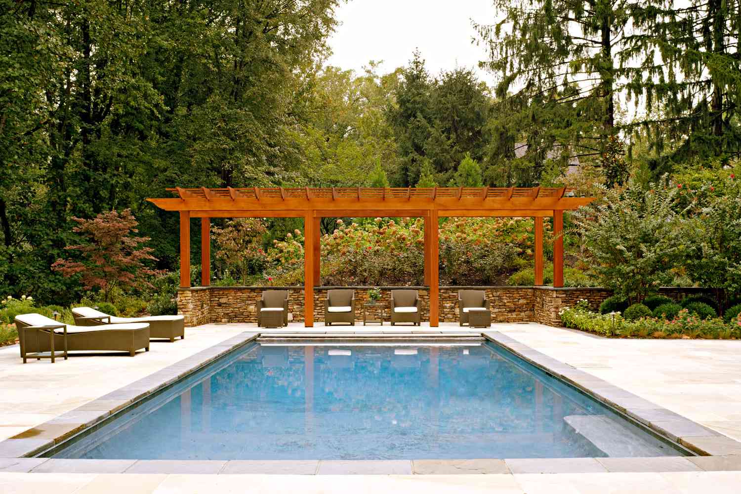 outdoor swimming pool with arbor over half wall