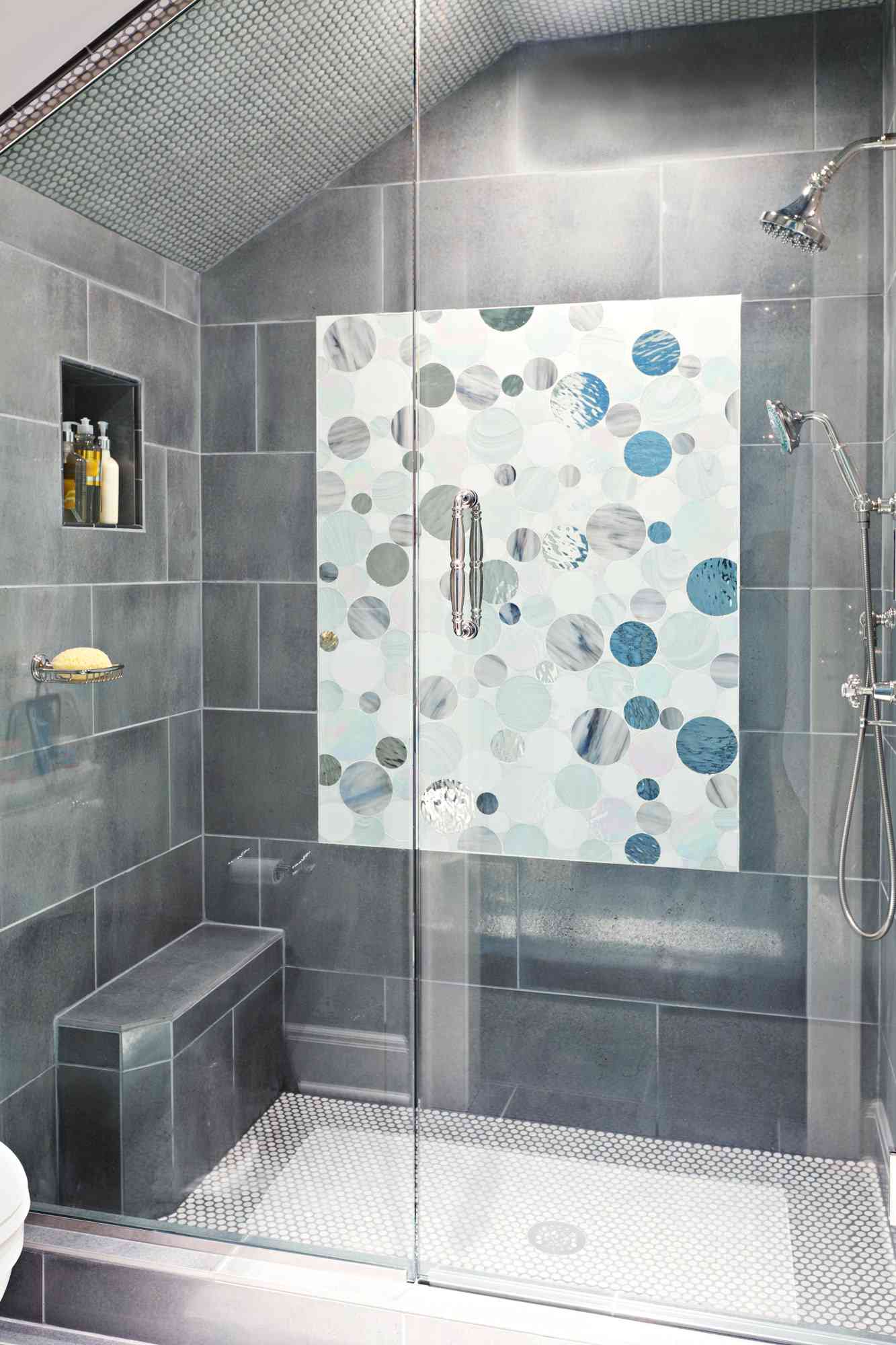 walk-in shower with circular pattern accent tile