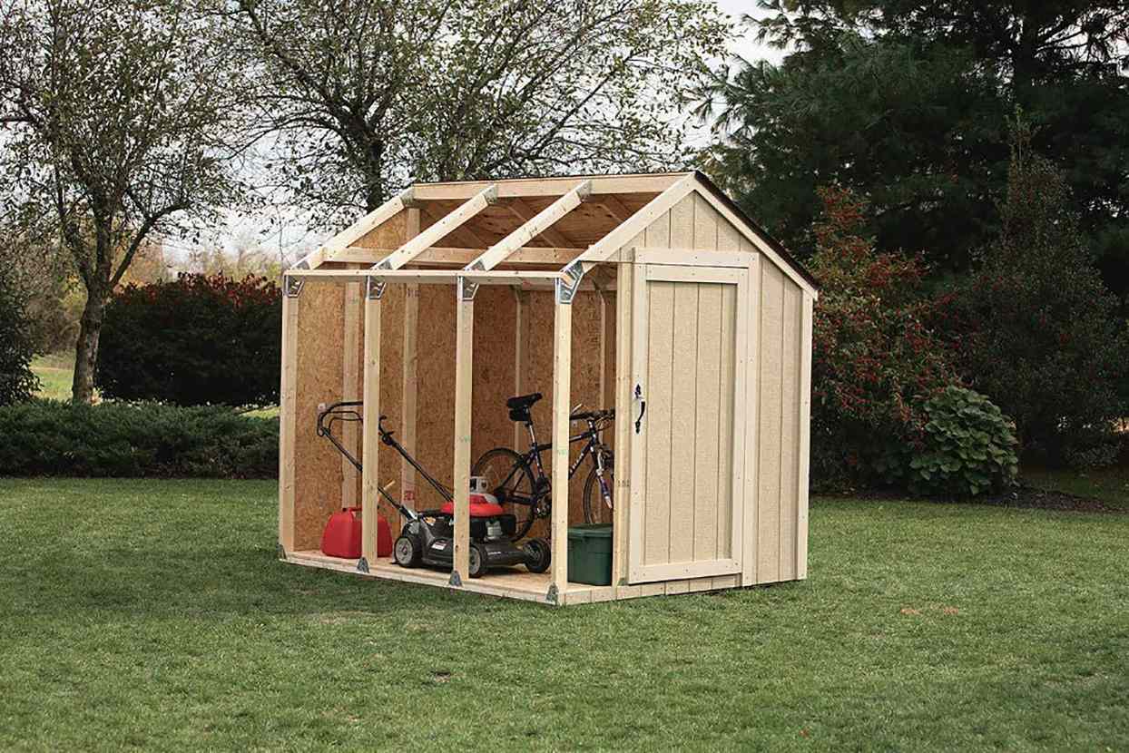 wood garden shed with exposed framing in backyard