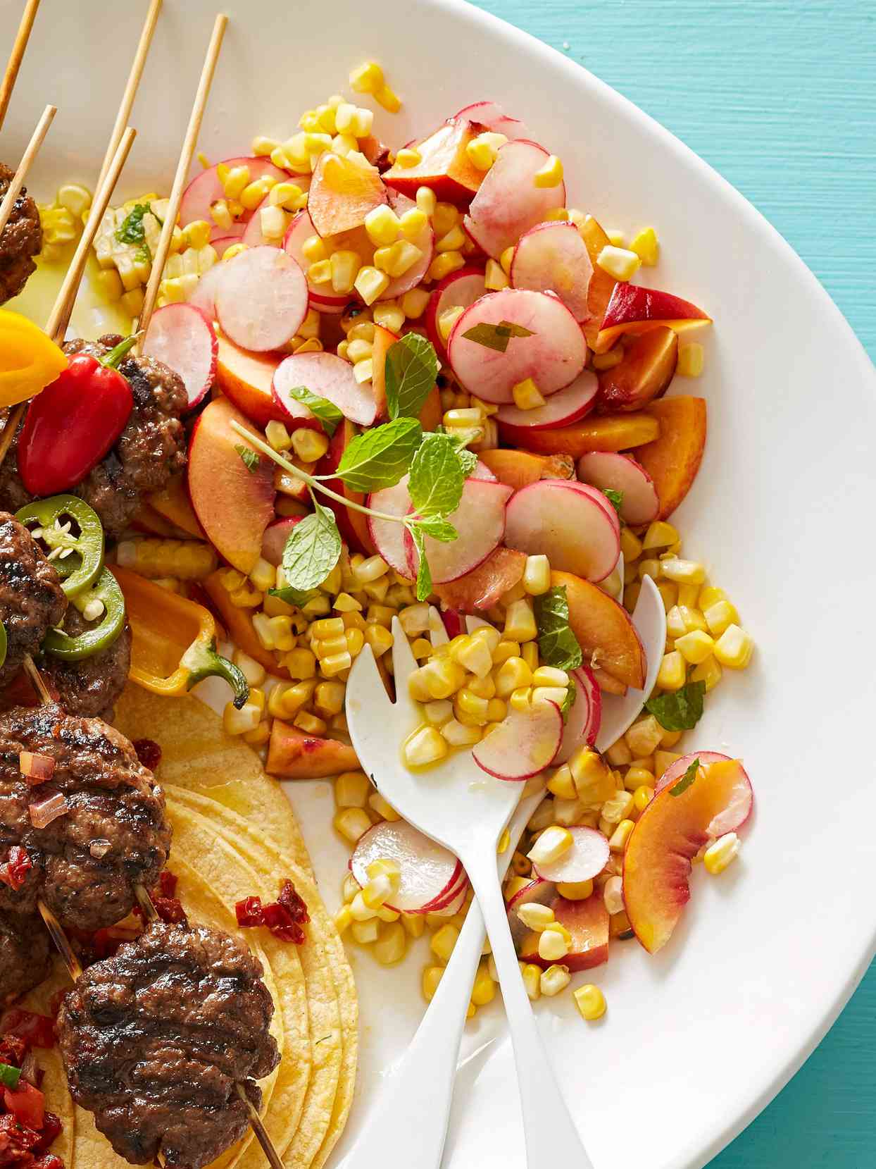 Corn Peach Salad on plate with kebabs