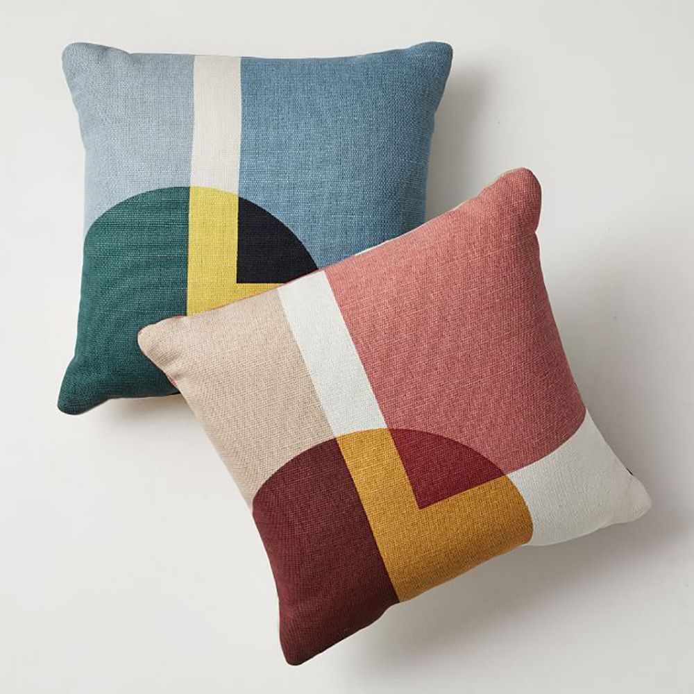 two colorful outdoor pillows against white background
