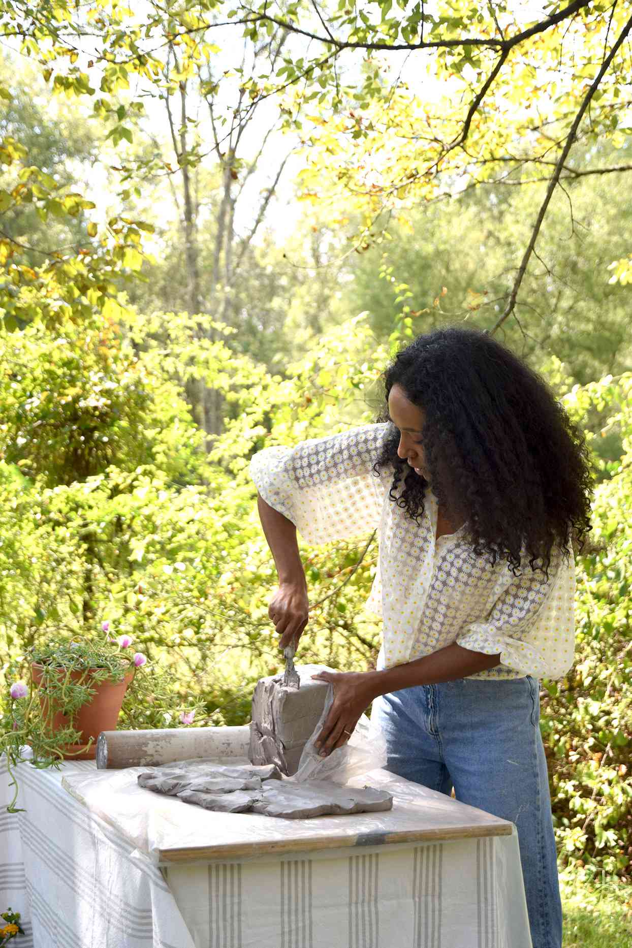 Artist Ronnie Nicole Robinson making artwork outdoors