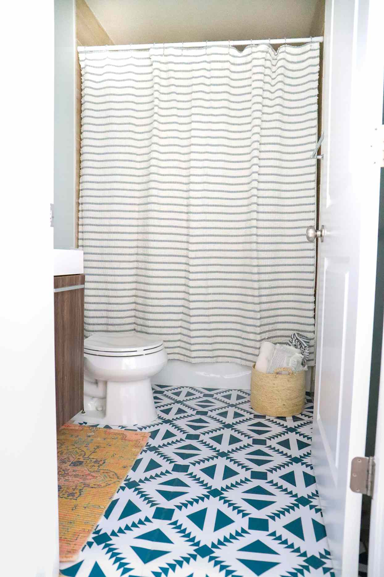 small bathroom with teal patterned floor tile