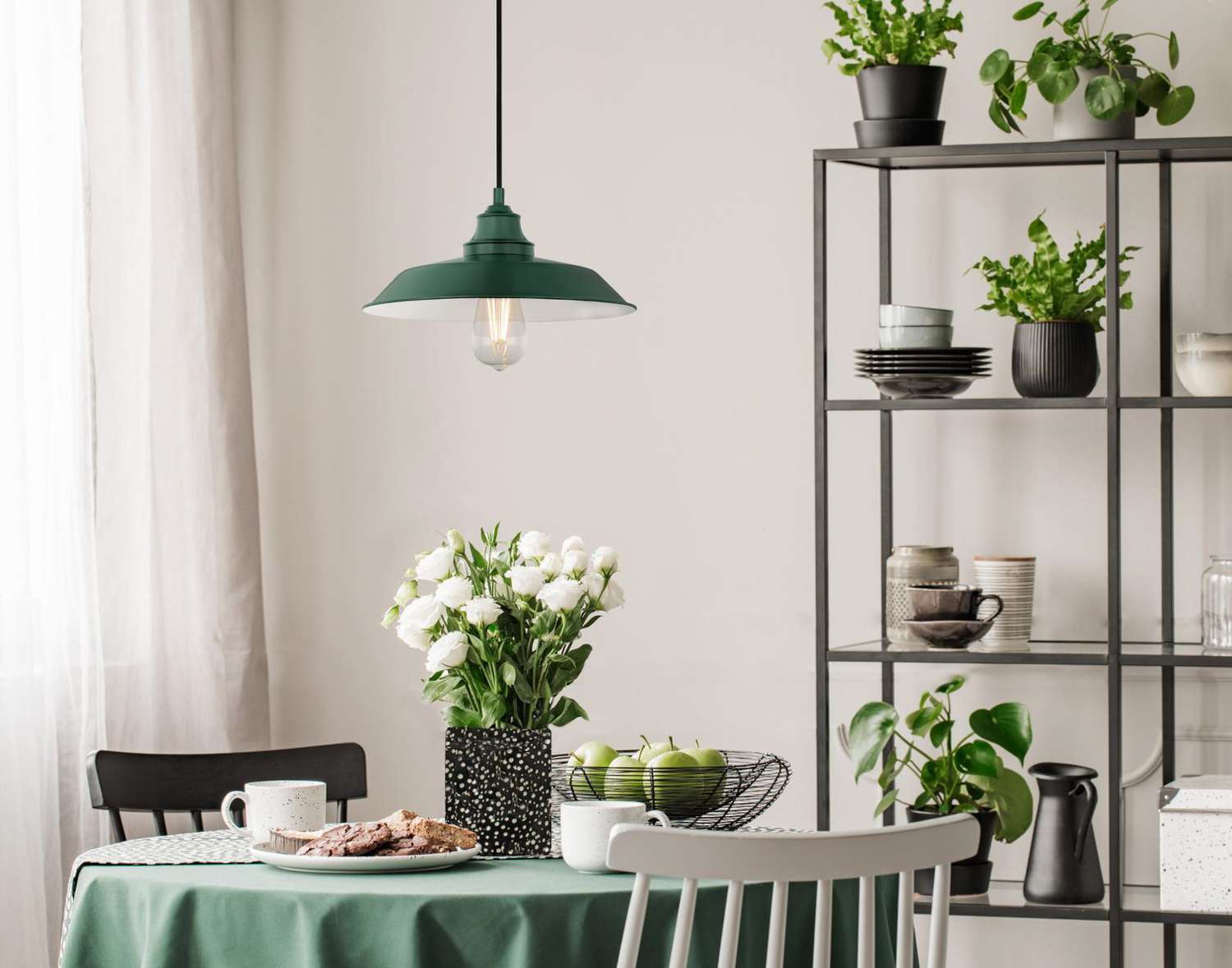 green and white dining area with hanging light