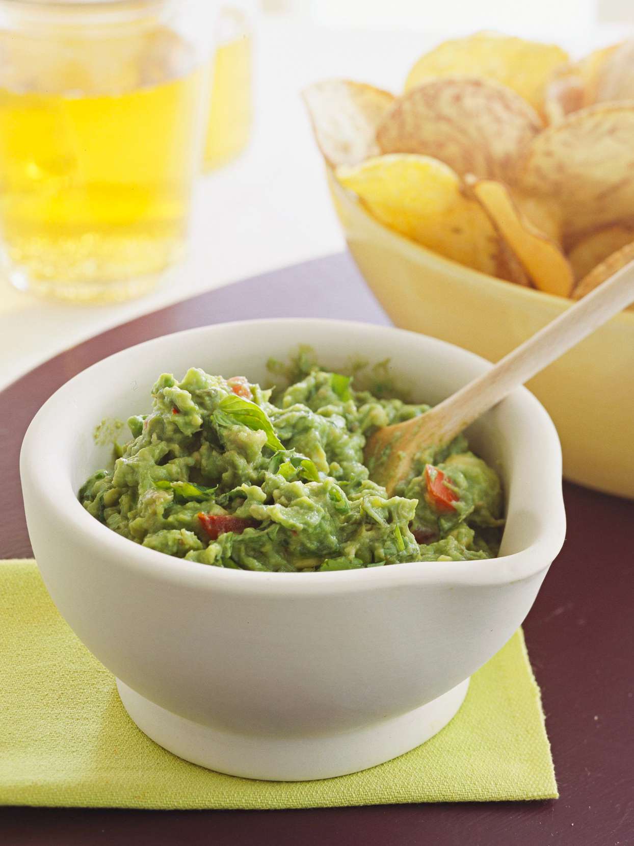Basil Guacamole in white bowl with chips