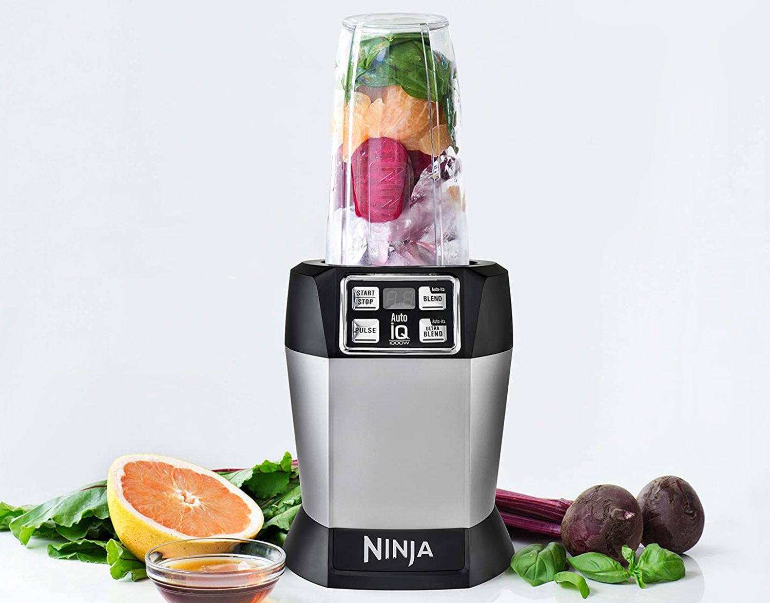 nutri ninja blender with fresh vegetables and fruit