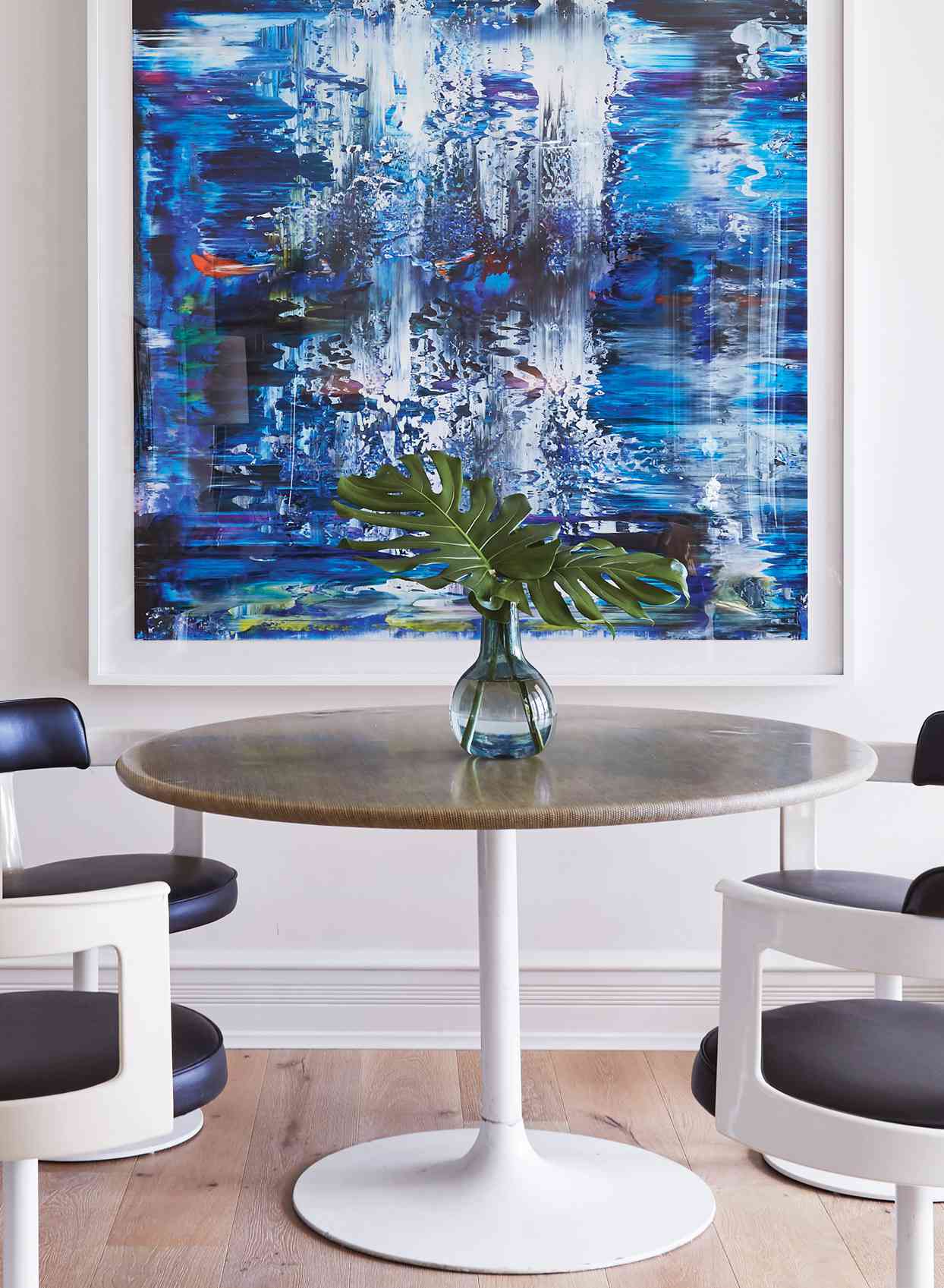 large blue abstract artwork raffia-topped tulip table