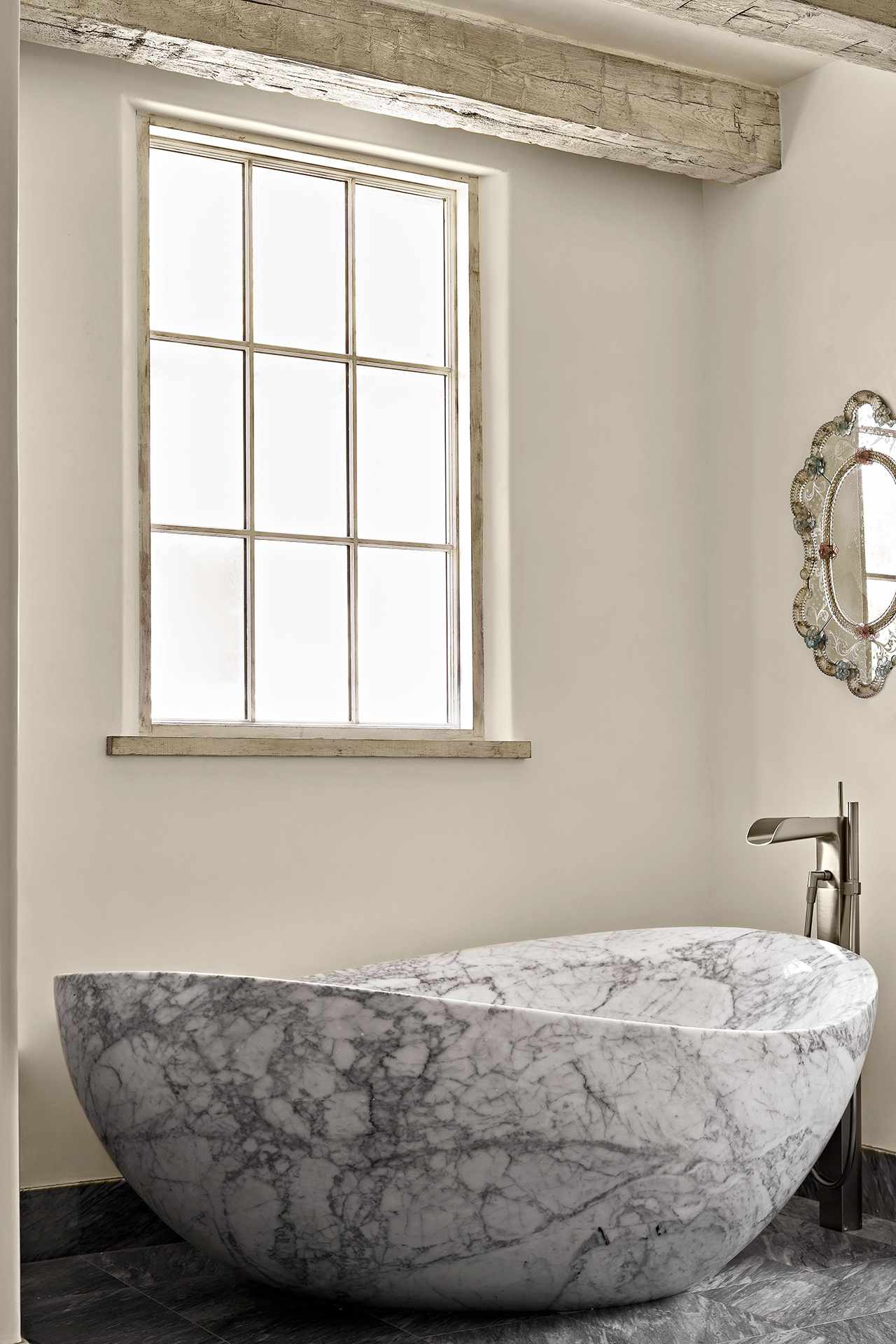 grey hand-carved stone bathtub