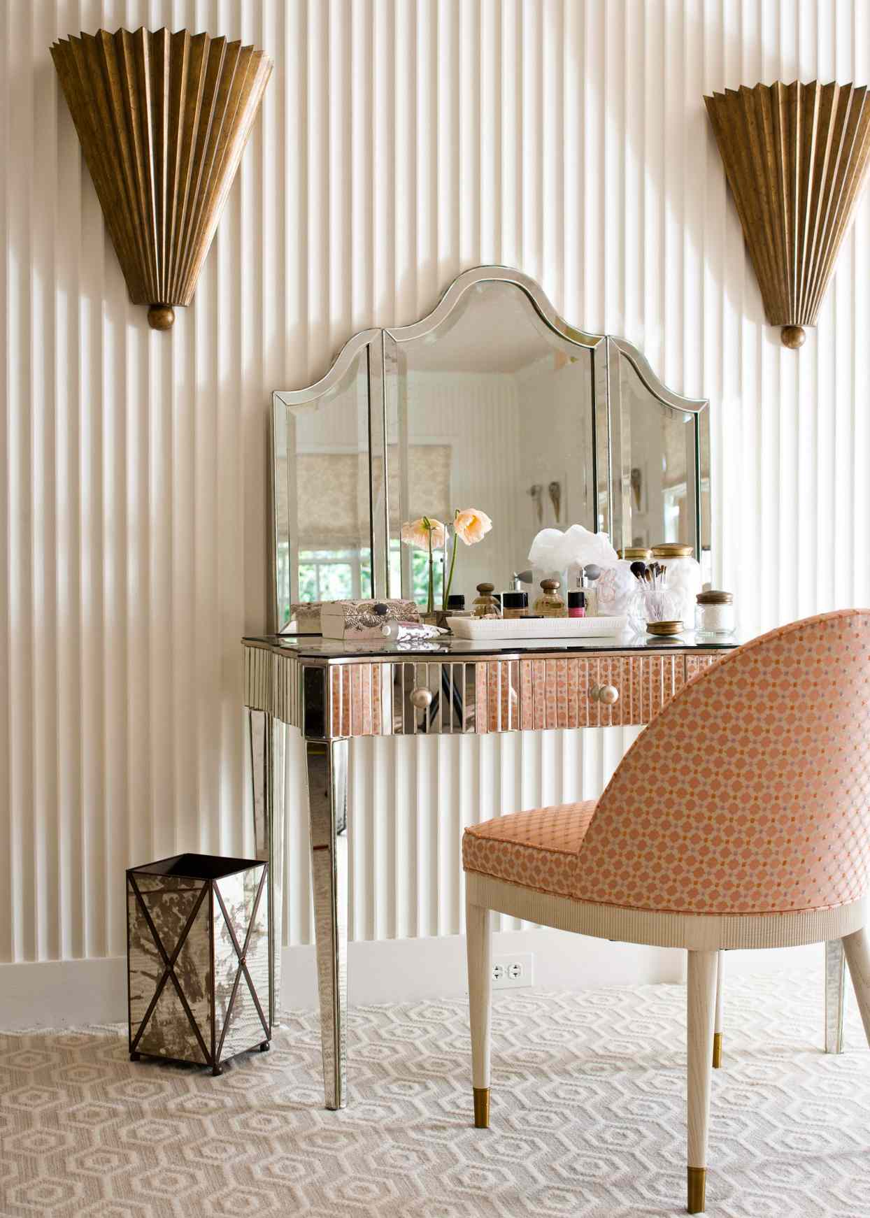 dressing table between two wall sconces