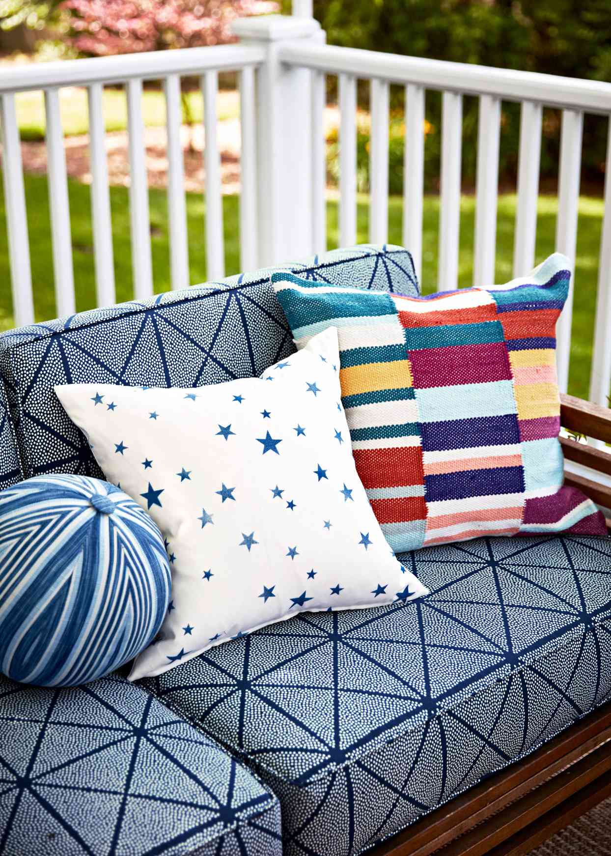 blue pattered outdoor seating with decorative pillows