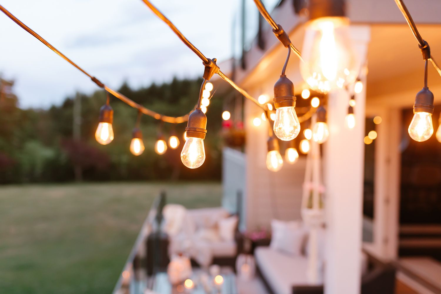 string lights hanging on patio at dusk