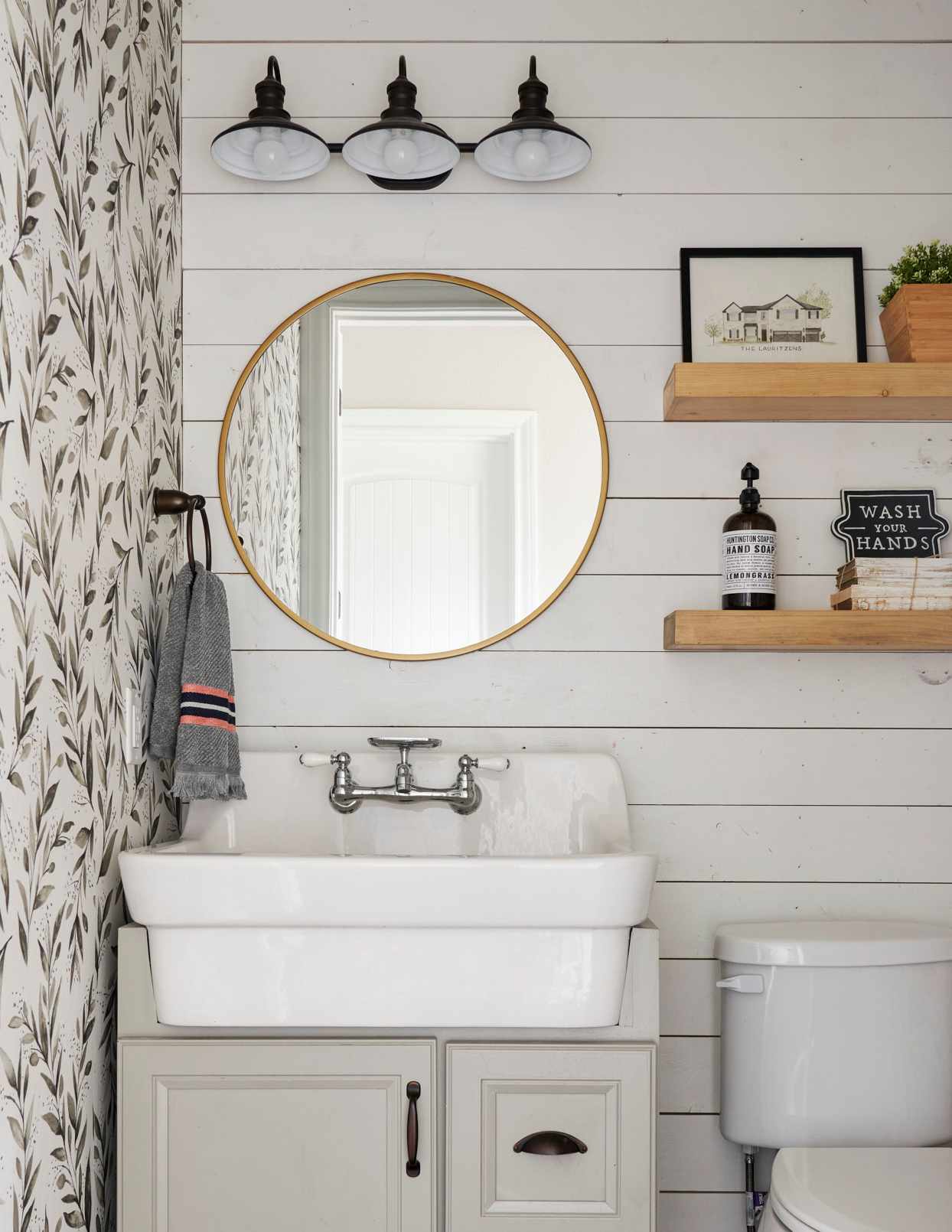 white bathroom with round hanging mirror