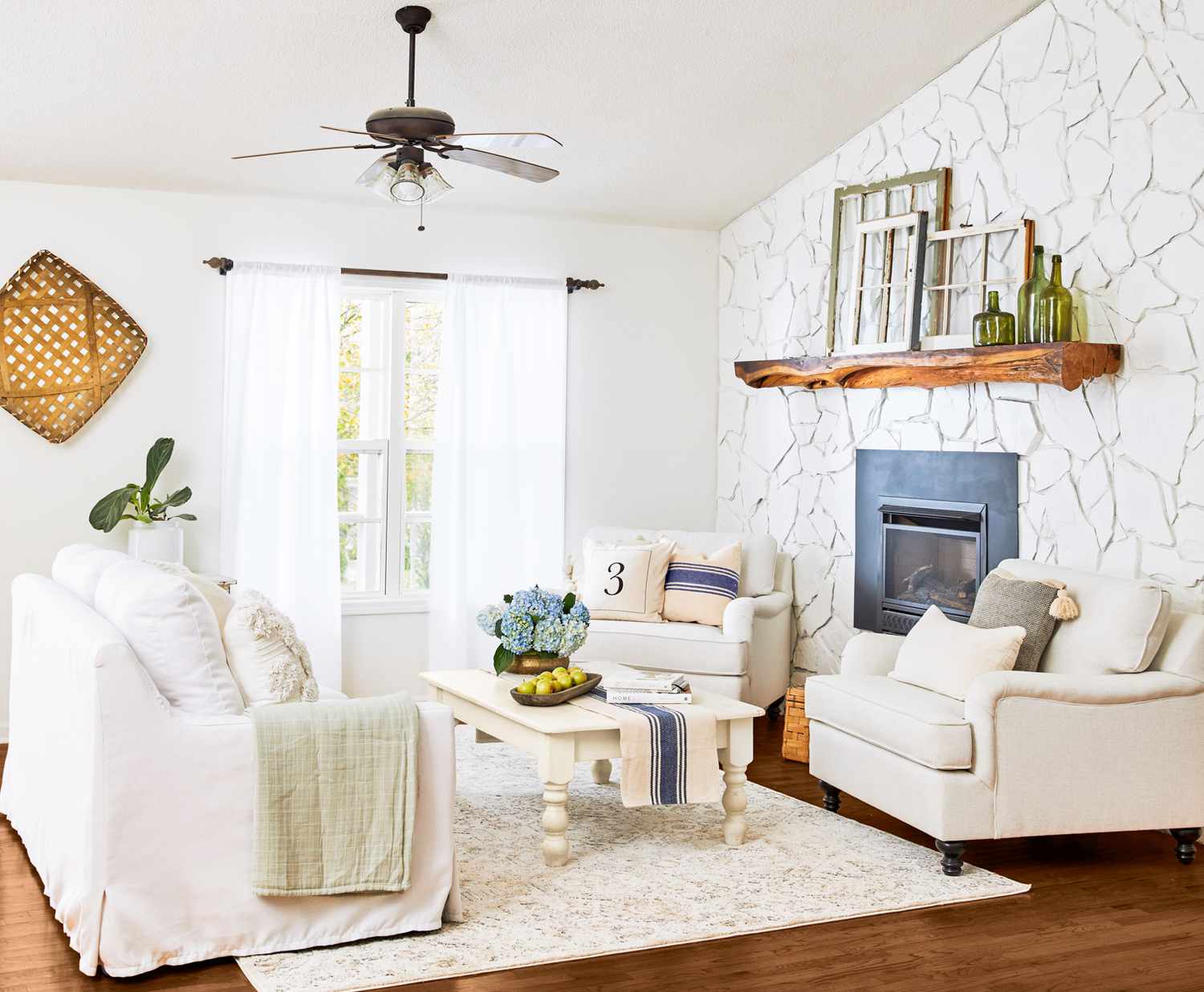 white living room with wood floors and fireplace