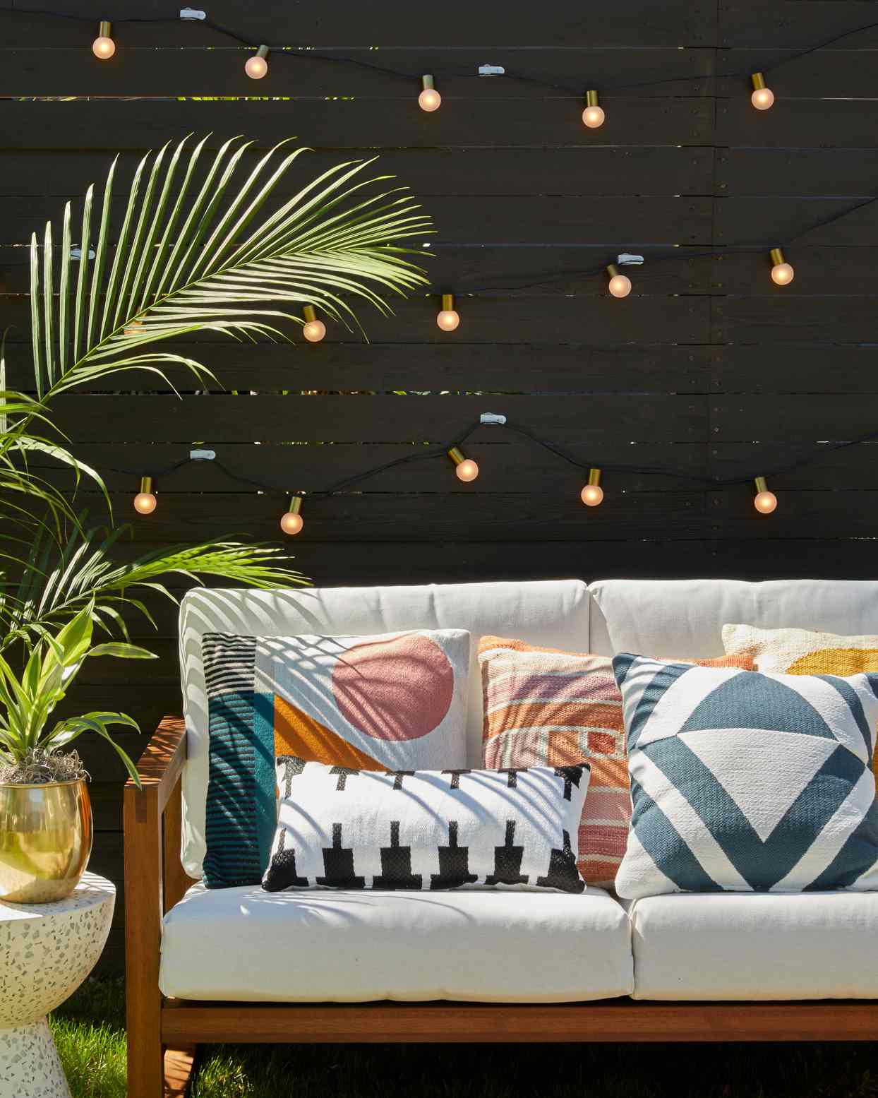 outdoor seating couch pillows string lights