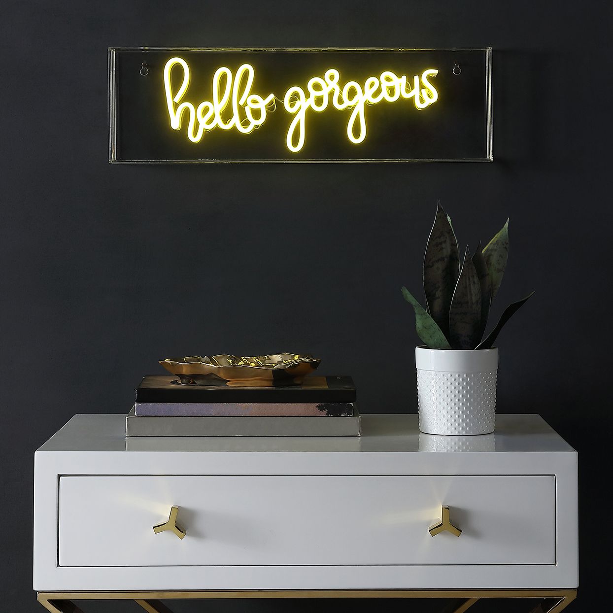 yellow neon sign above console table