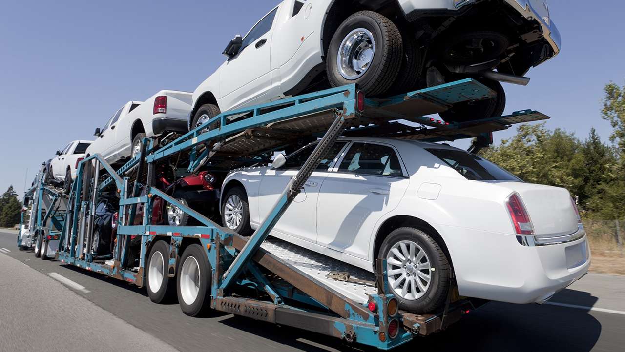 This photo depicts a rear of a trailer transporting cars from customers who read Easy Auto Ship reviews.