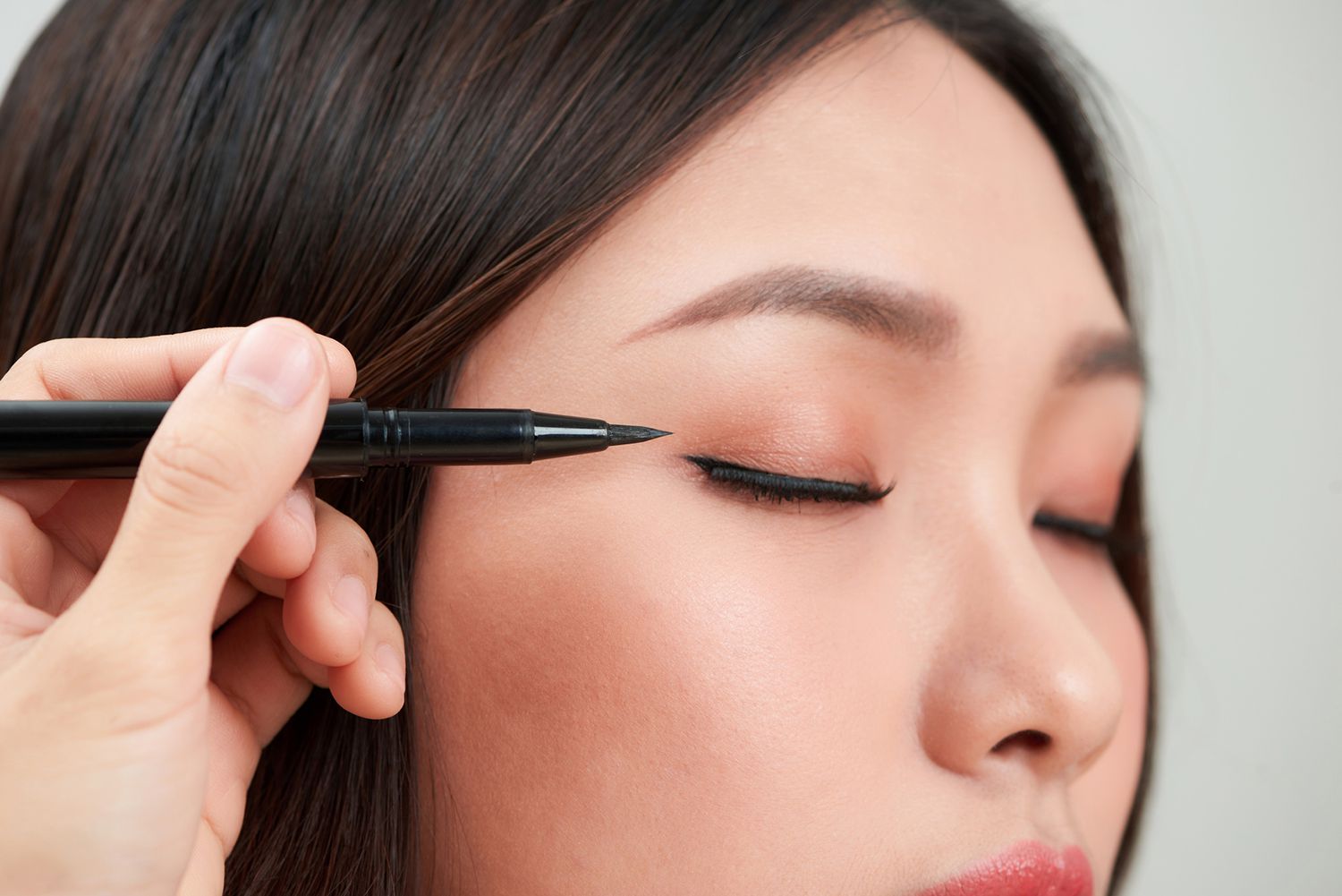 black liquid eyeliner being applied on woman