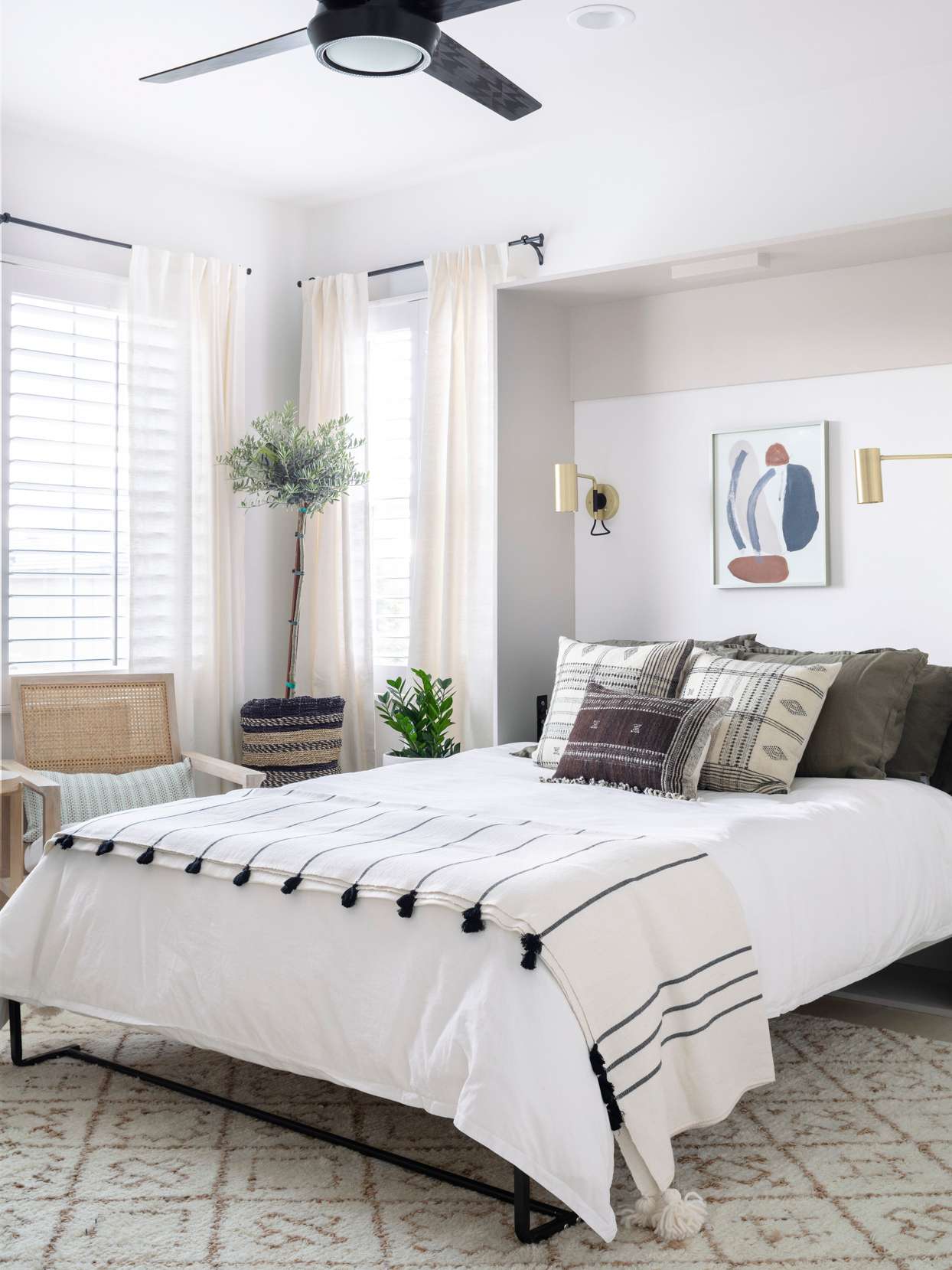 modern guest bedroom murphy bed neutral linens plants