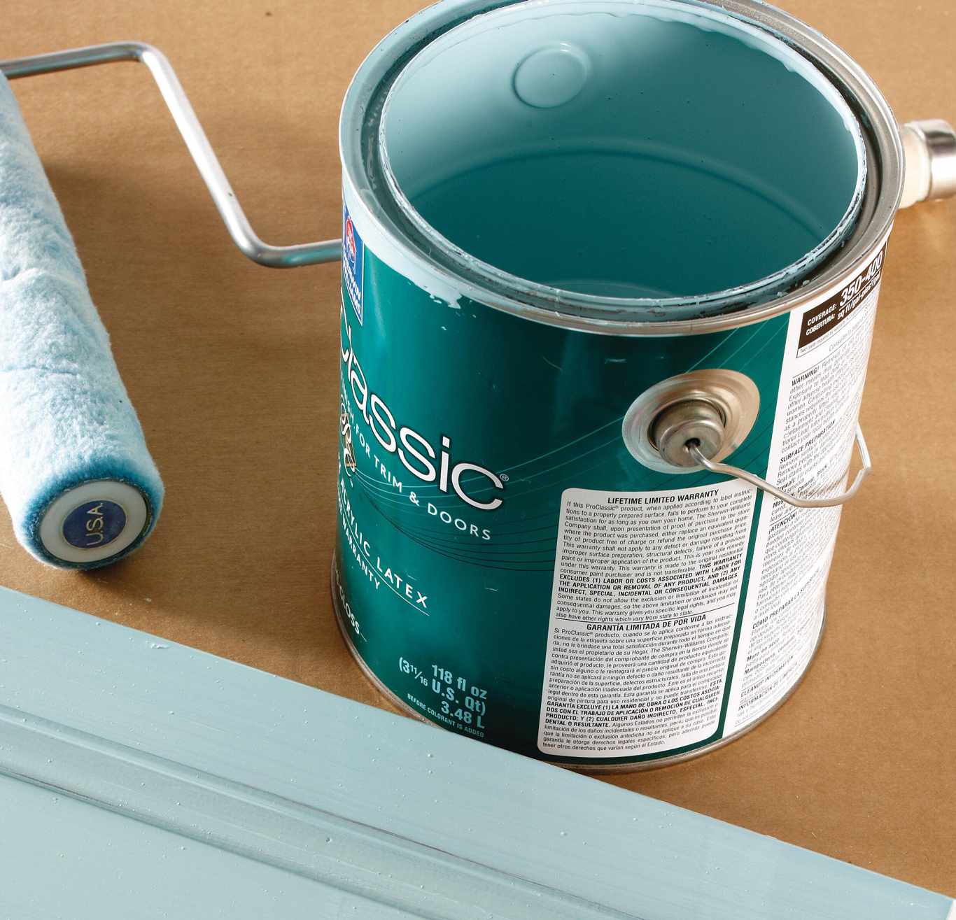 teal blue paint can with paint roller