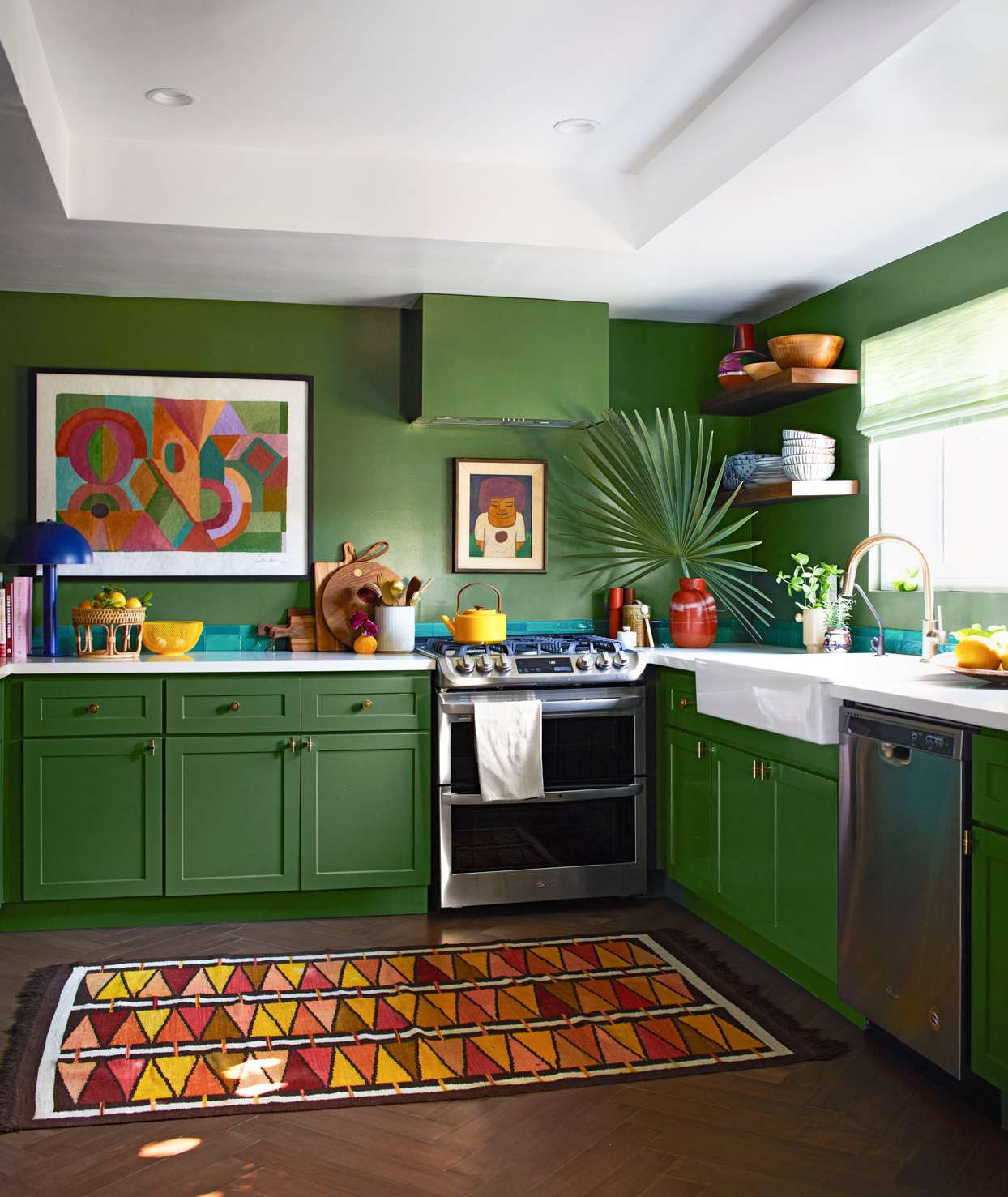 green kitchen with colorful modern art features