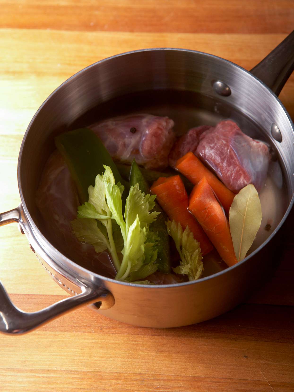 pot with giblets, carrots, and celery