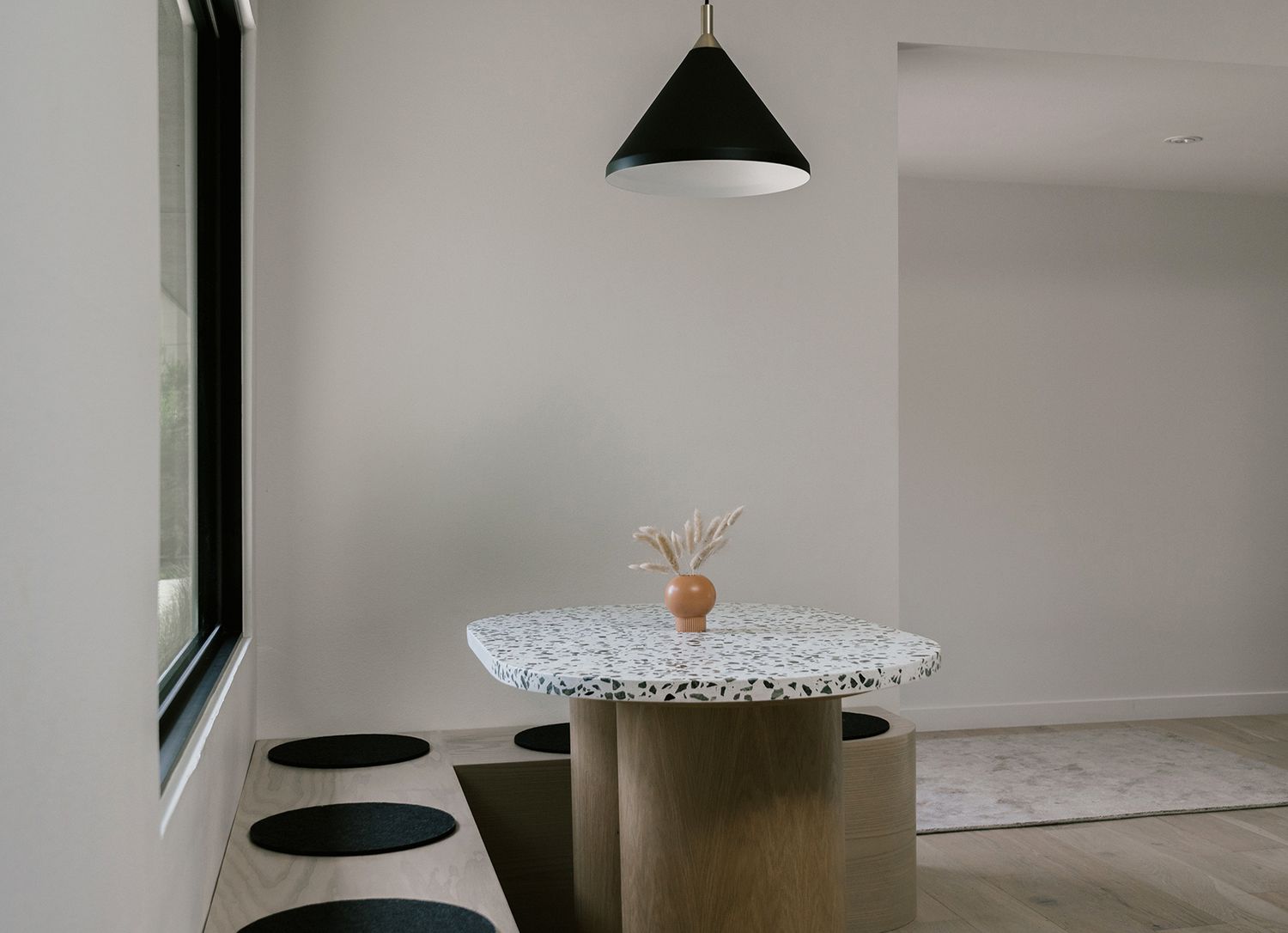 neutral Scandinavian Japandi-style minimalist banquette corner white walls