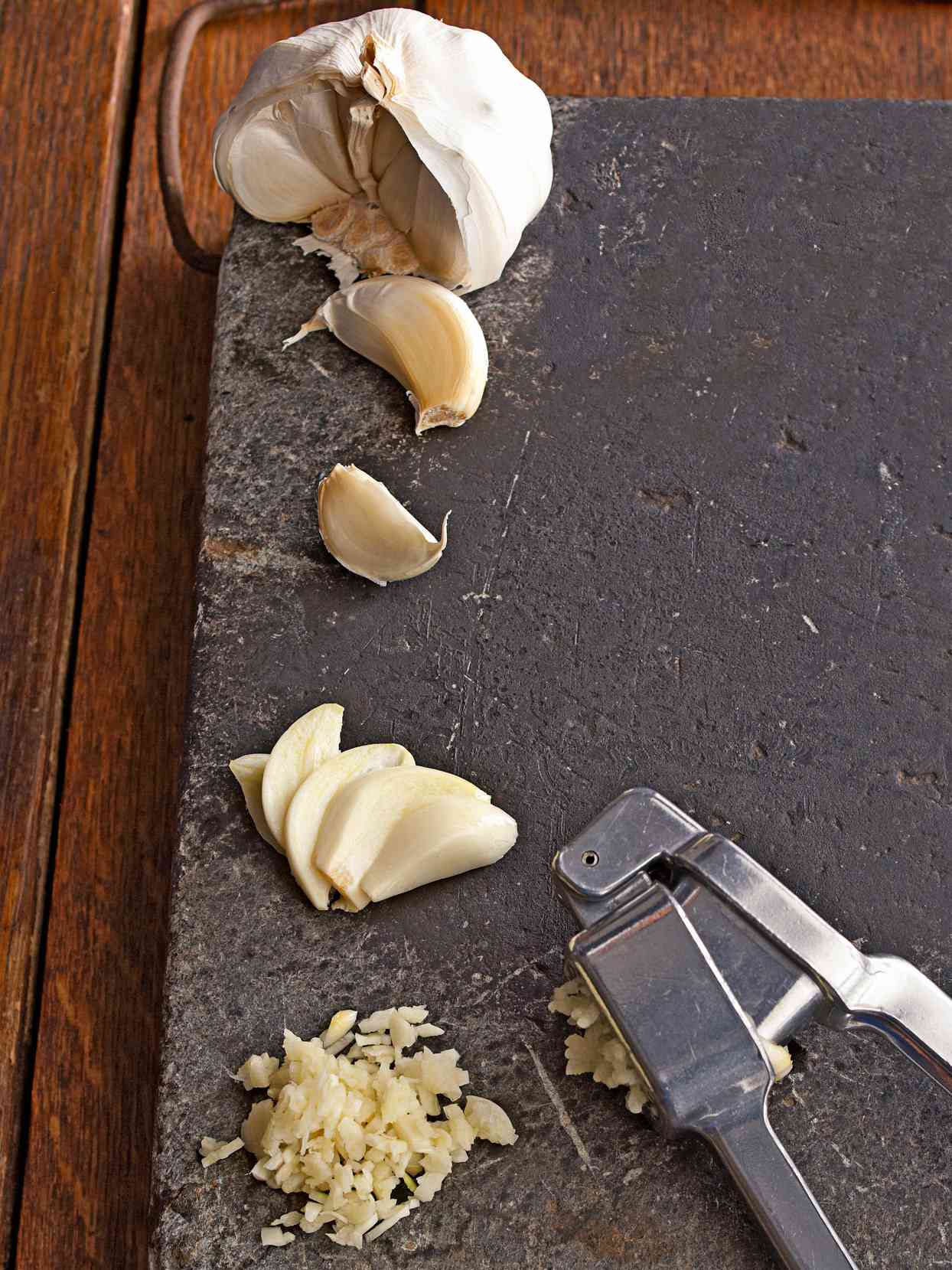 garlic clove in stages on cutting board