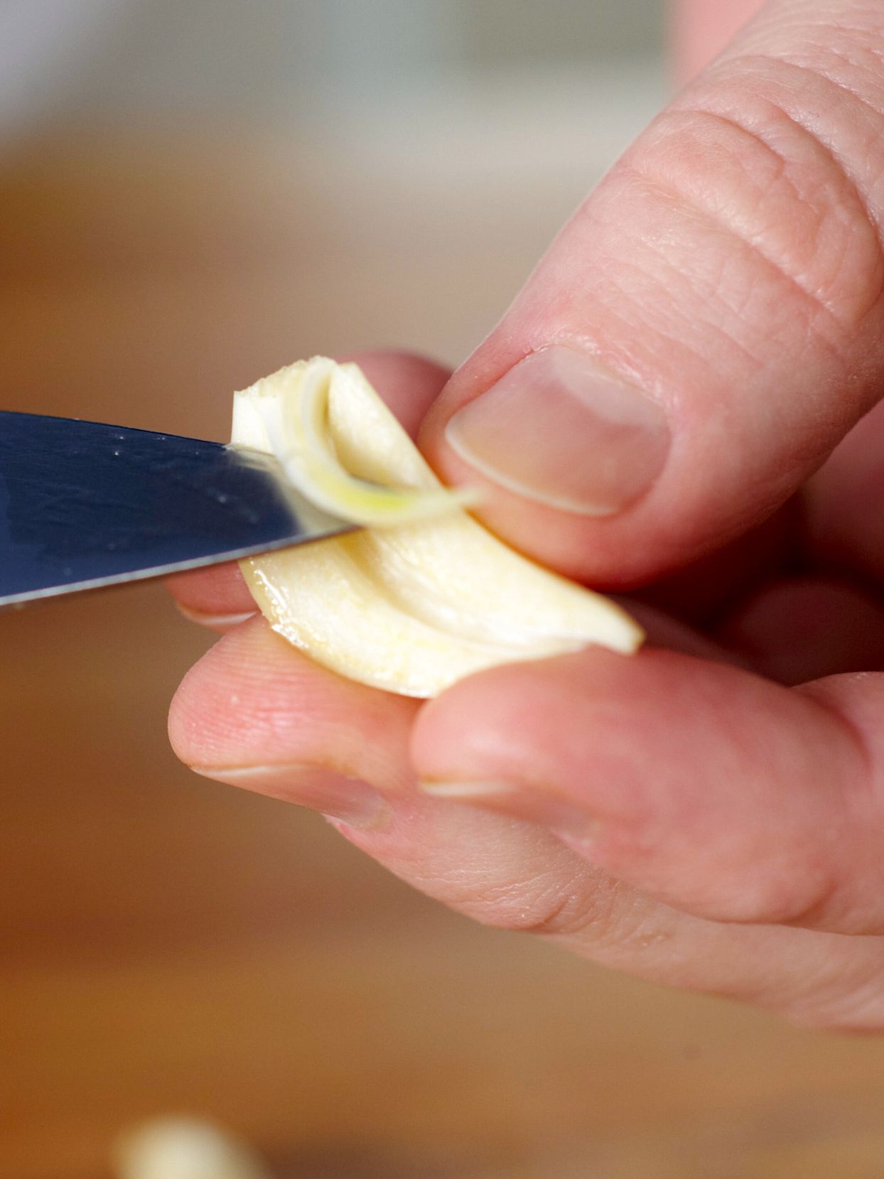 removing garlic sprout with knife